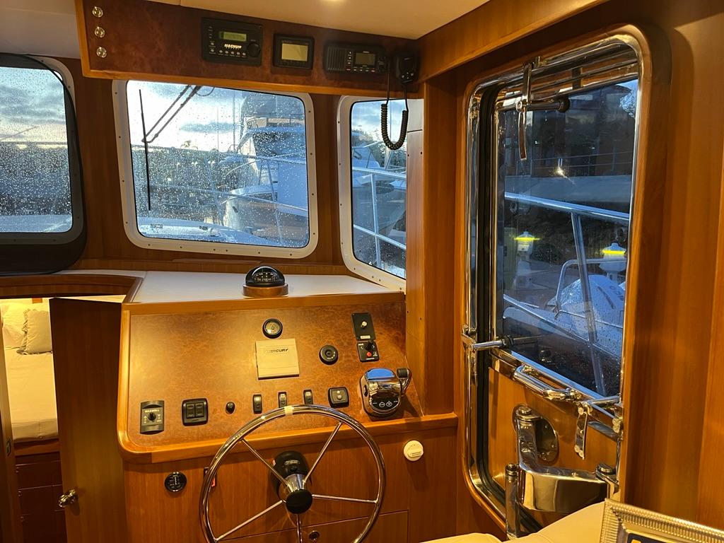Interior of 2025 Bracewell 41 boat with wooden helm and navigation equipment.