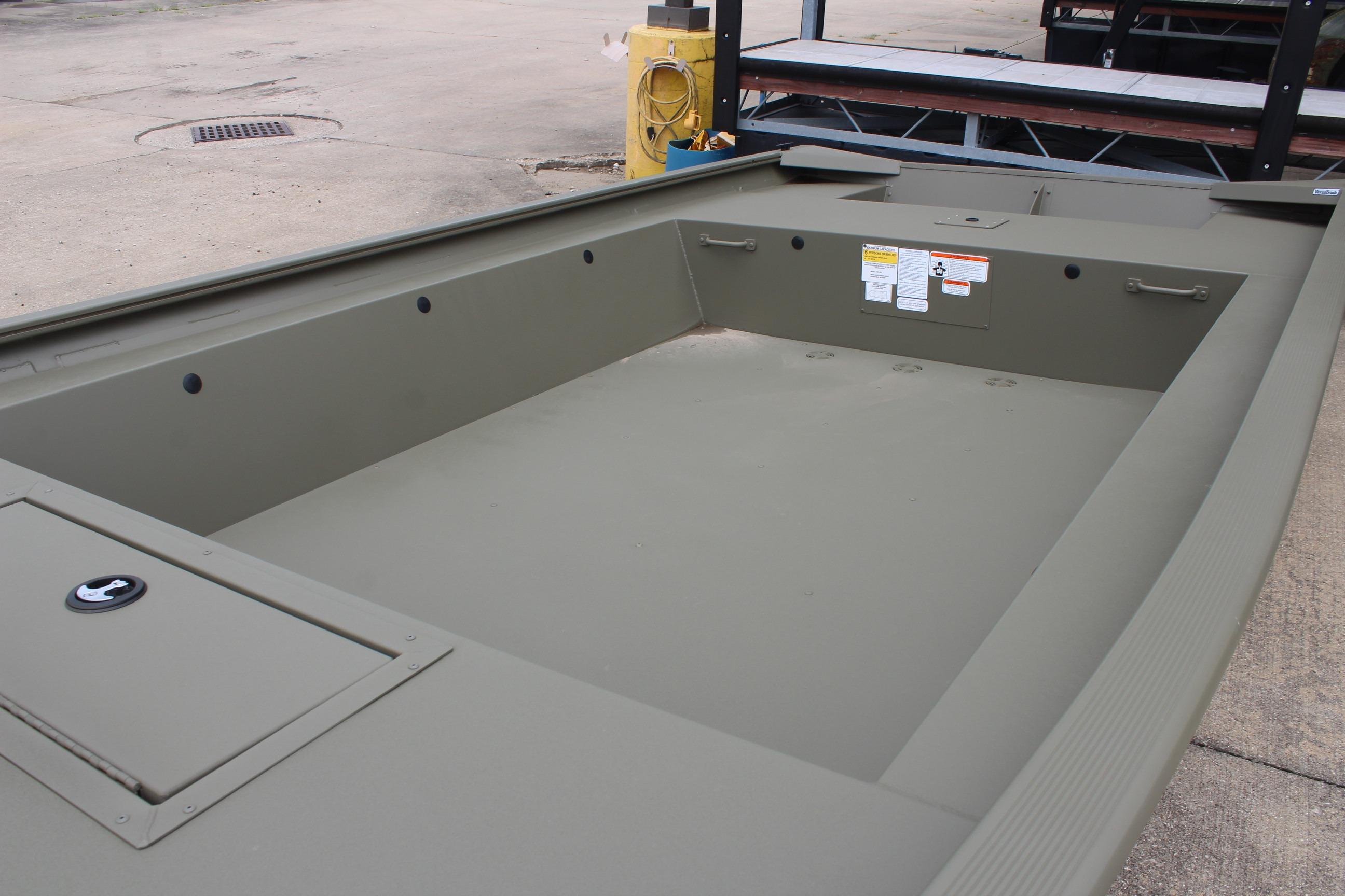 2026 Tracker Grizzly 1754 Utility boat interior, showcasing spacious, durable design on concrete surface.