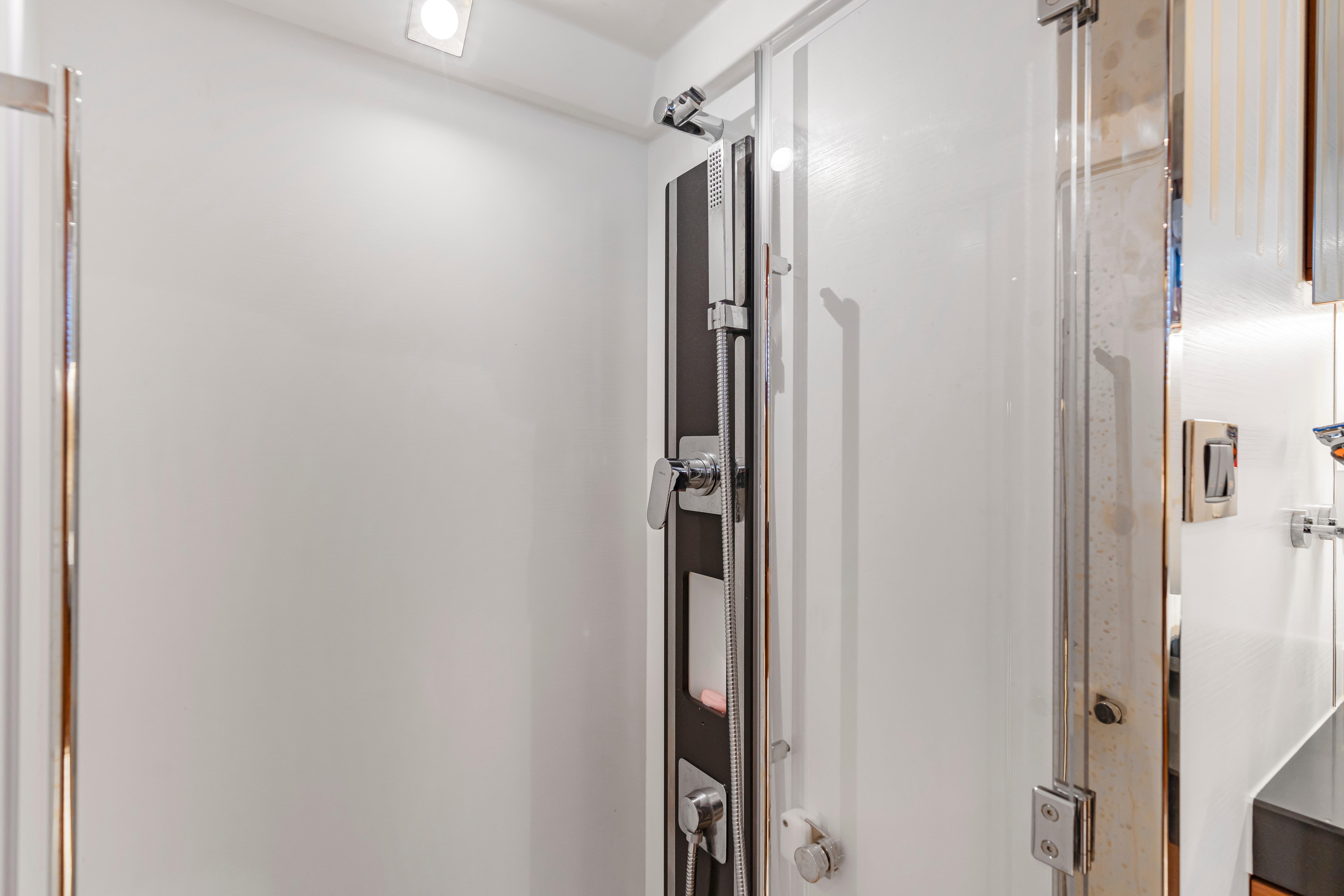 Modern shower area in a 2017 Prestige 500 yacht, featuring sleek fixtures and glass door.