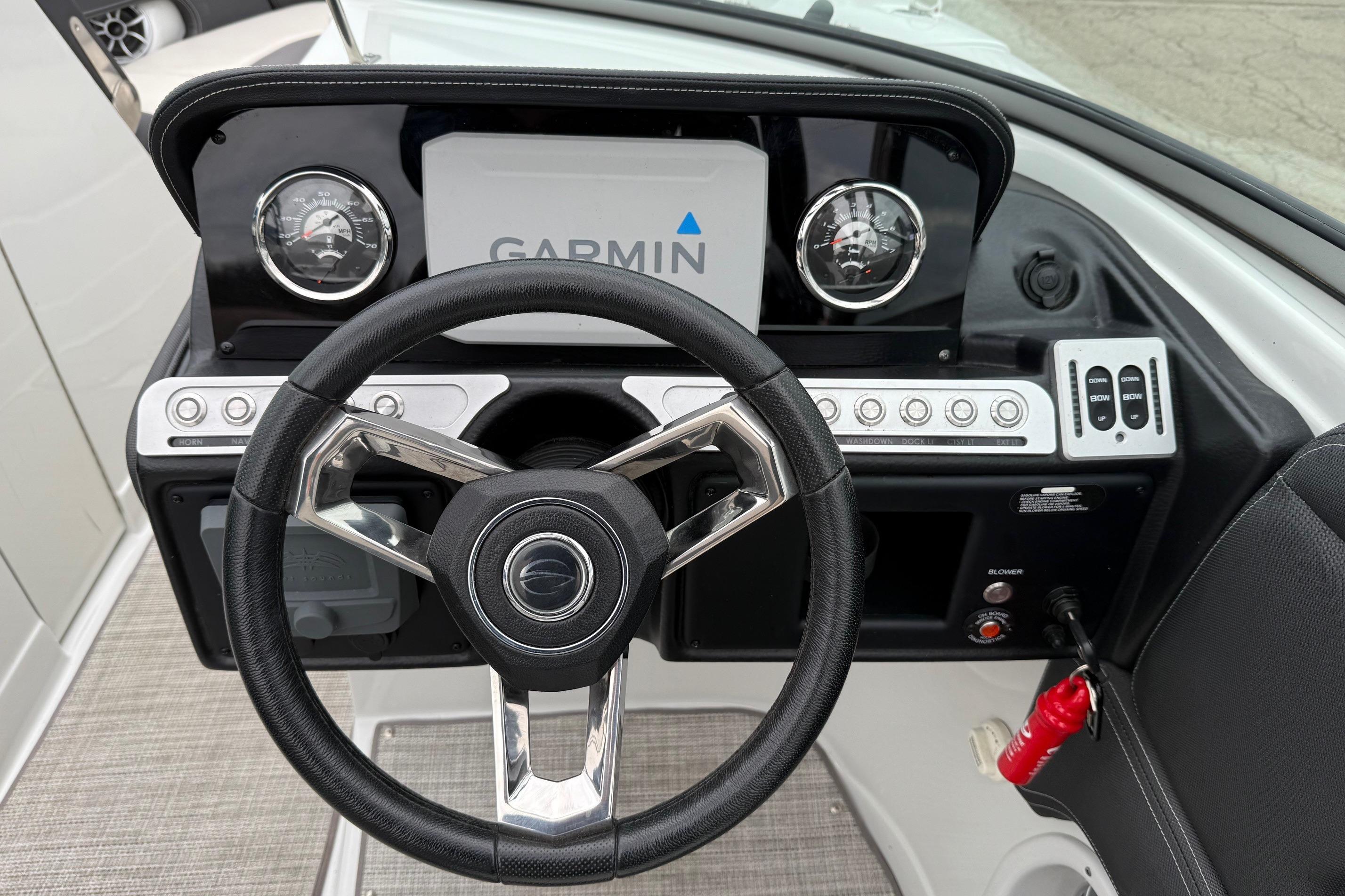 2022 Crownline 255 SS boat dashboard with Garmin display and steering wheel.