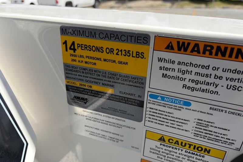 Capacity and safety warning labels on a 2026 Hurricane SunDeck Sport 2050 OB boat.