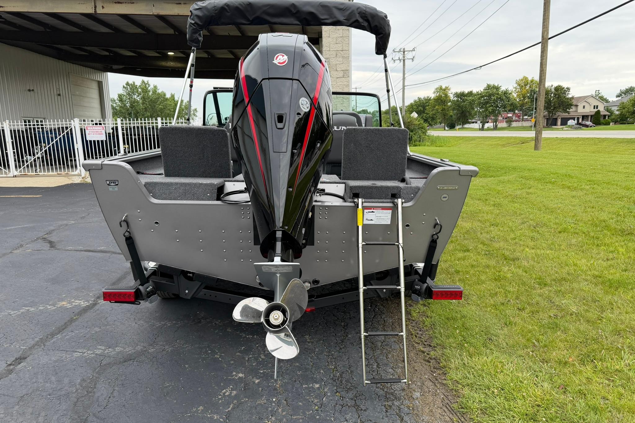 2027 Lund 2075 Impact XS boat rear view with motor and ladder.