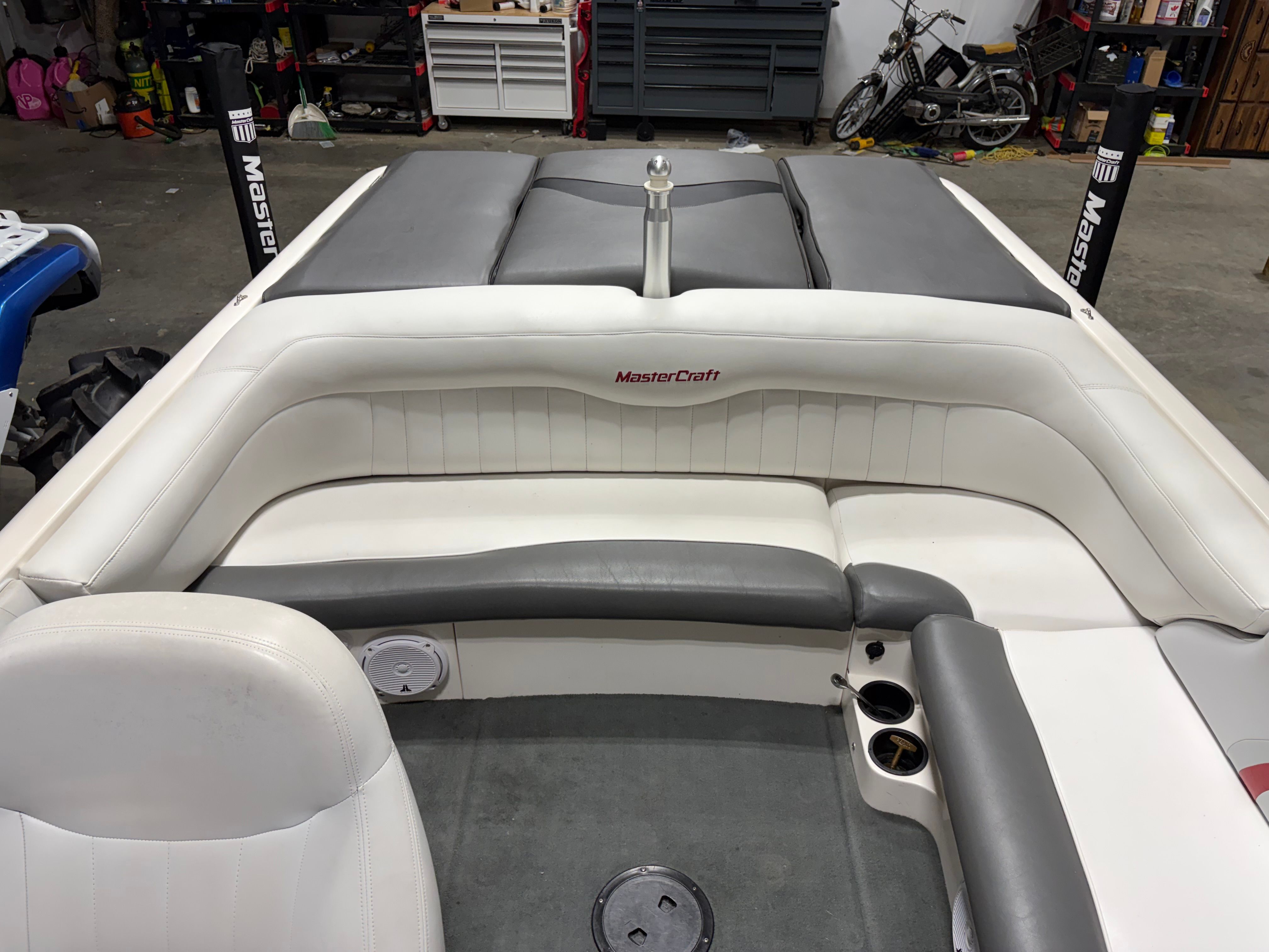 Interior of a 2004 MasterCraft X2 boat in a garage.