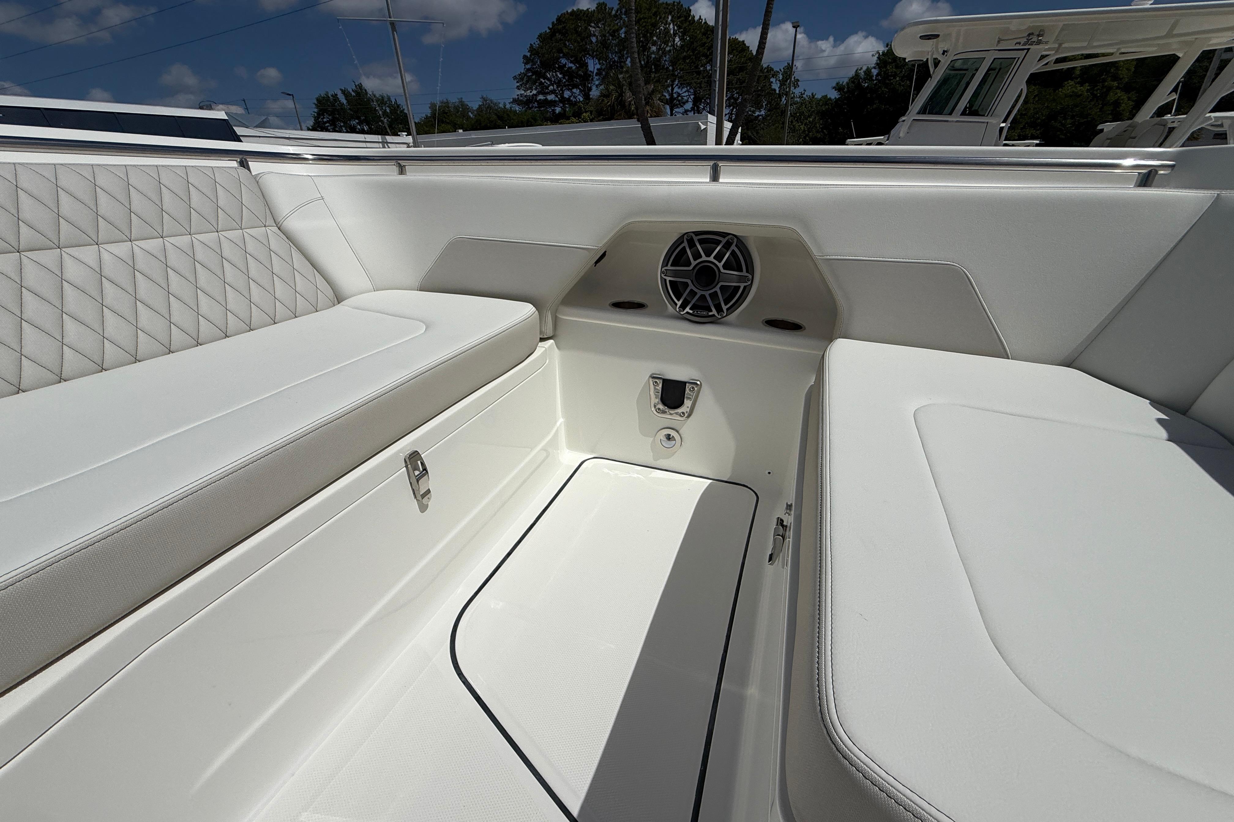 Luxurious seating area on 2026 World Cat 400 DC-X Island boat, featuring white upholstery.