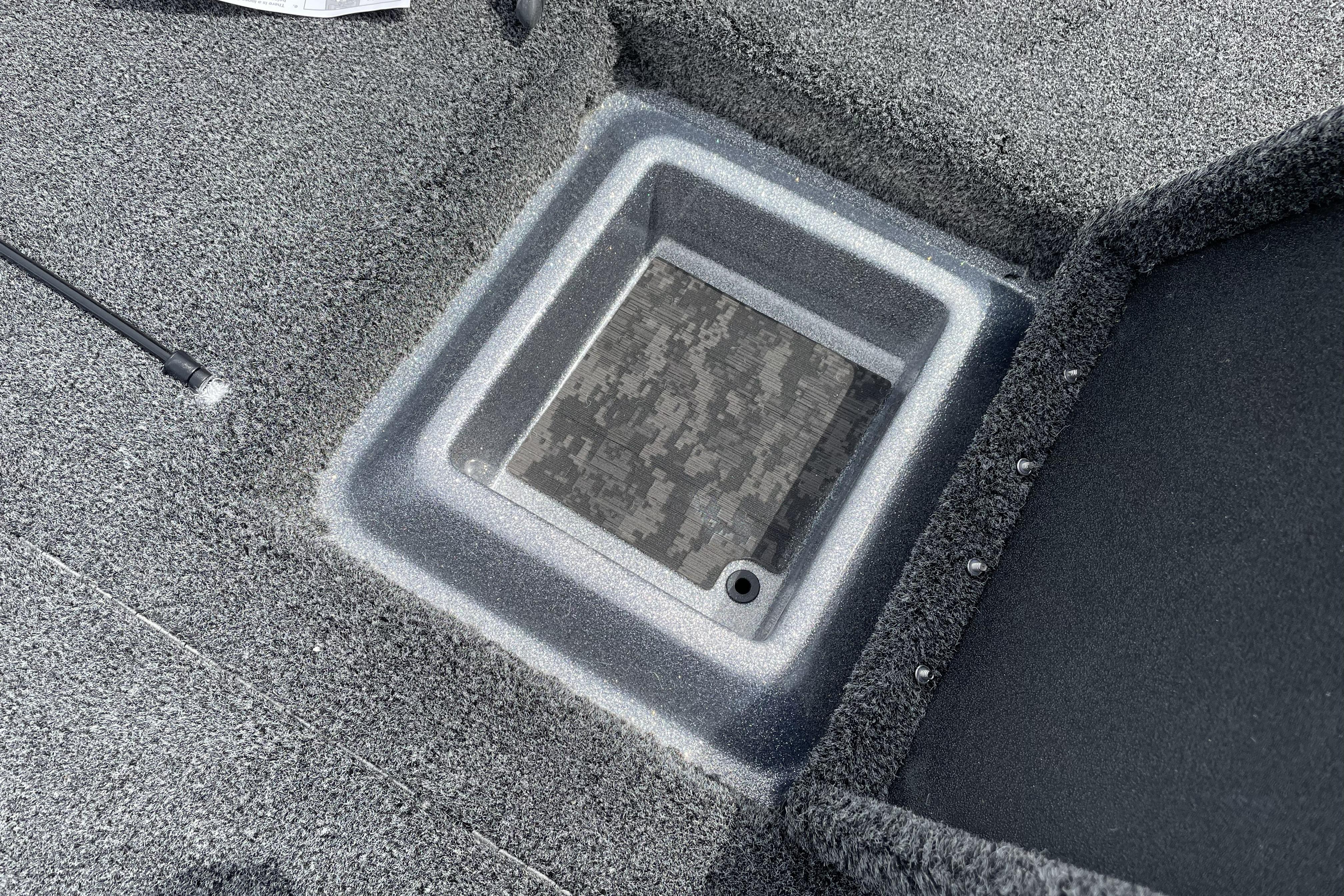 Carpeted storage compartment on 2026 Nitro Z21 XL boat deck.