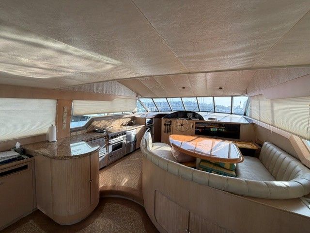 Interior of a 1990 custom motor yacht with kitchen and seating area.