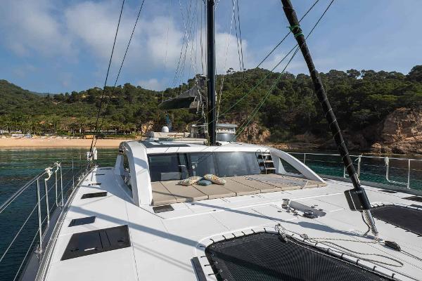 Luxury Privilege Signature 580 yacht, 2025 model, anchored near a scenic coastline.