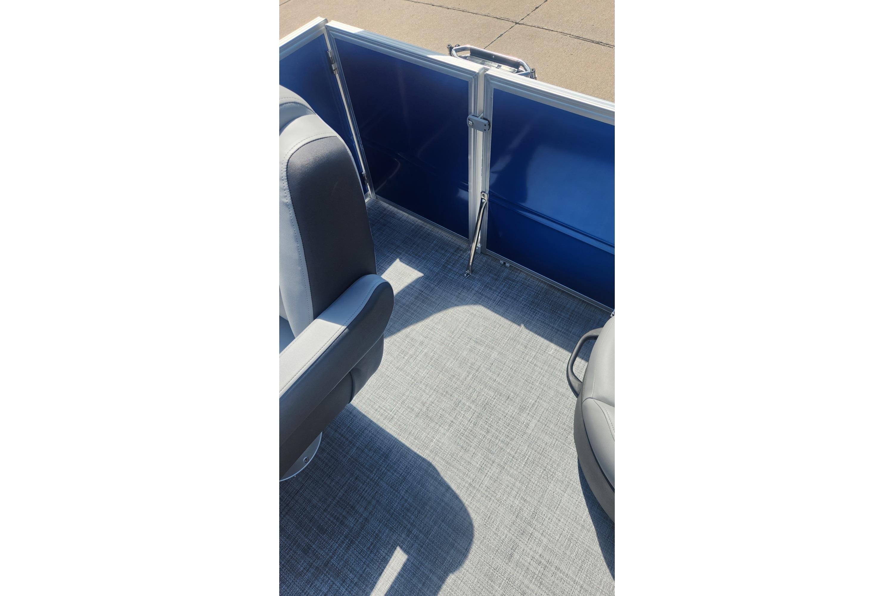 2026 Sun Tracker Party Barge 16 DLX interior with gray seating and blue panel.