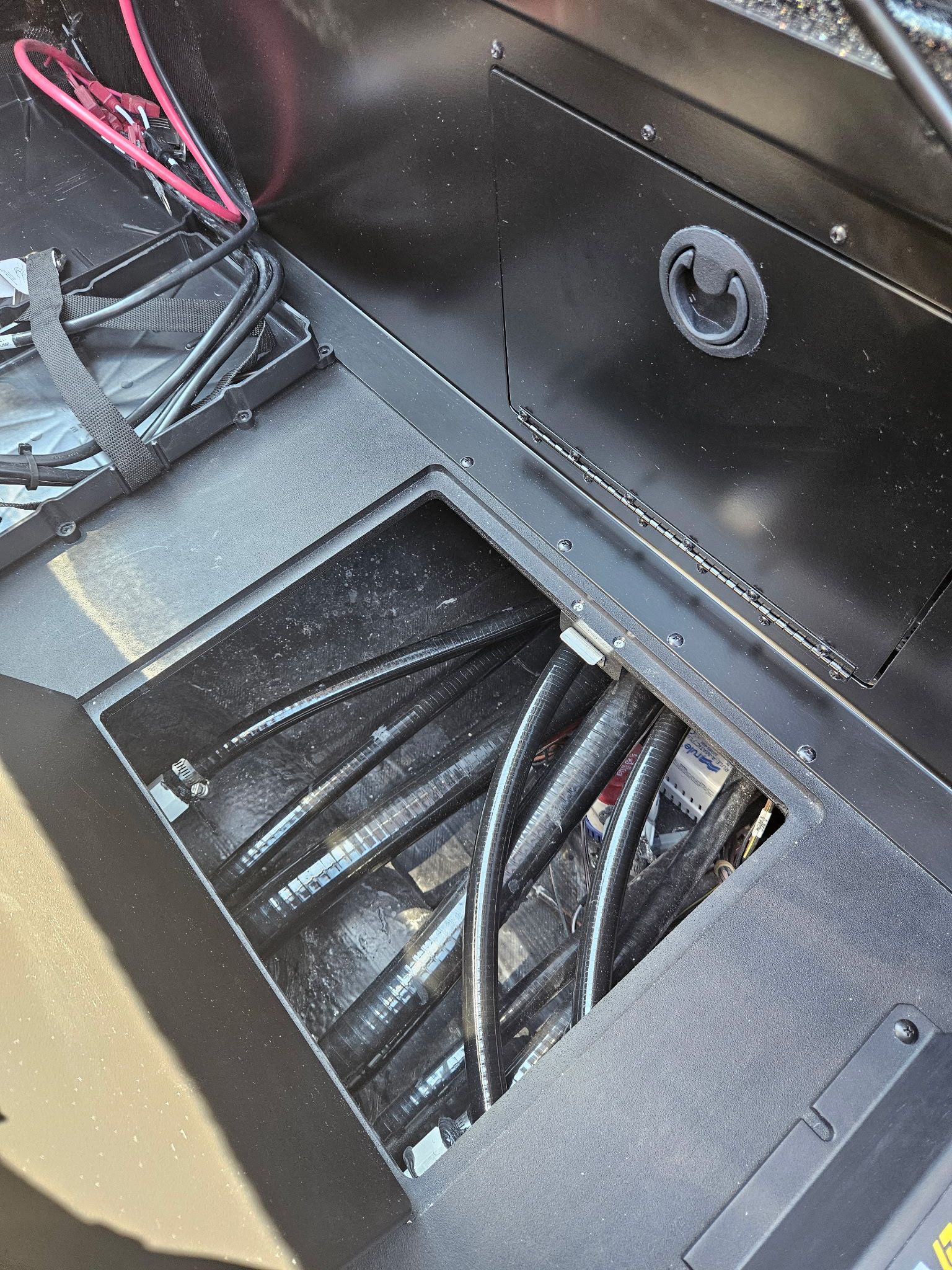 Interior view of Caymas 201 Pro 2027 with cables and storage.