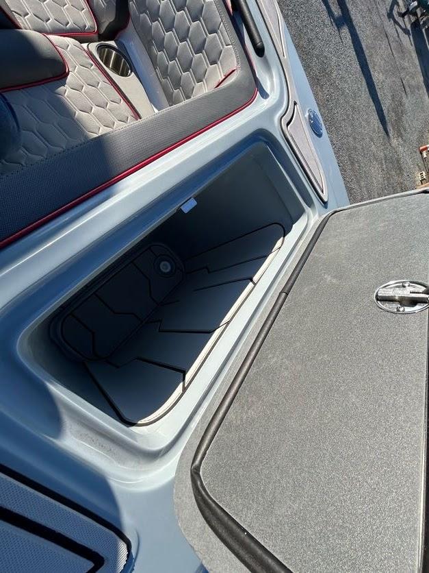 2024 Glasstream 32 GSX boat storage compartment with open lid and cushioned seating.