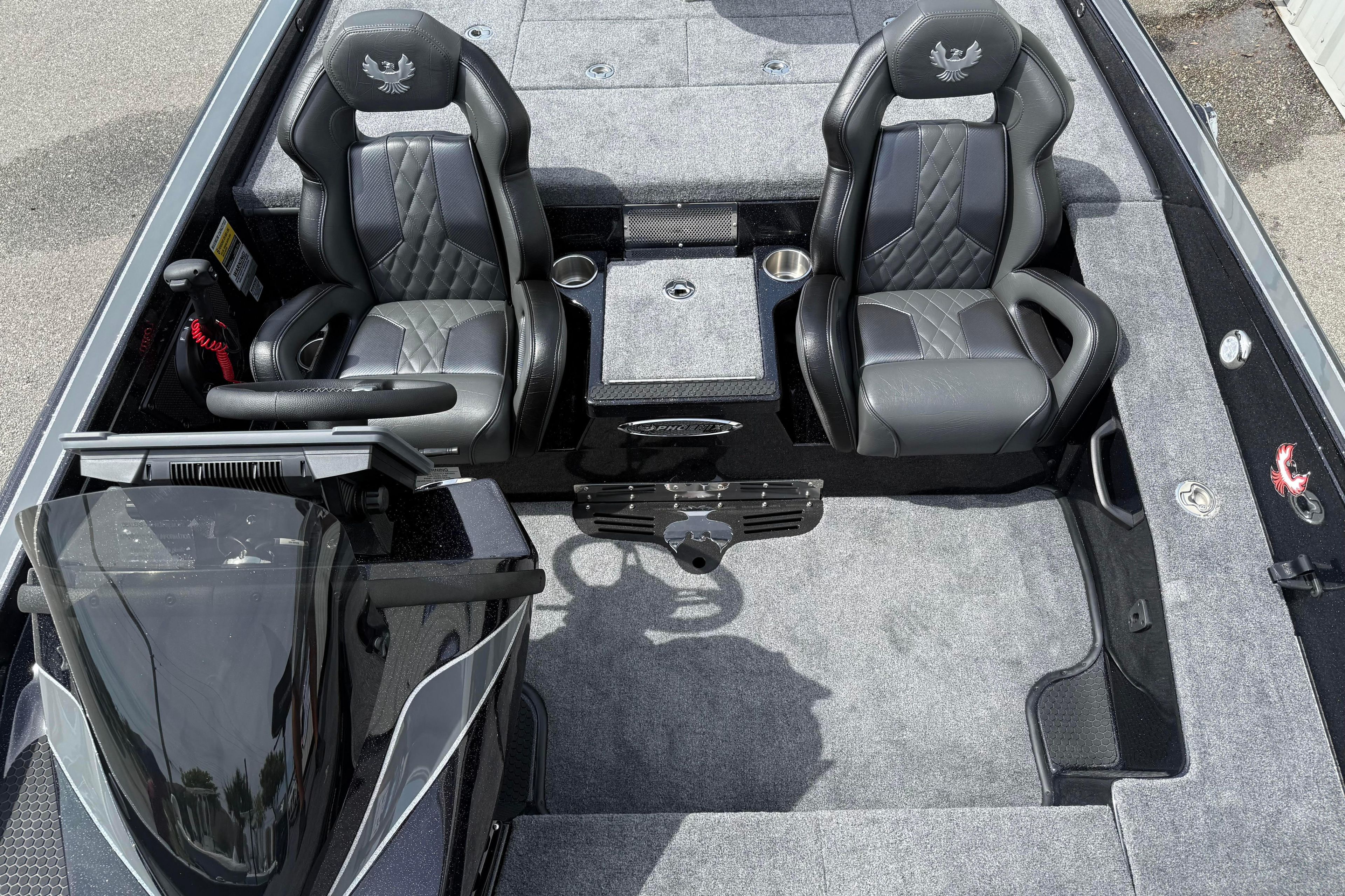 Interior of 2027 Phoenix 921 Elite X boat with dual black seats and steering console.