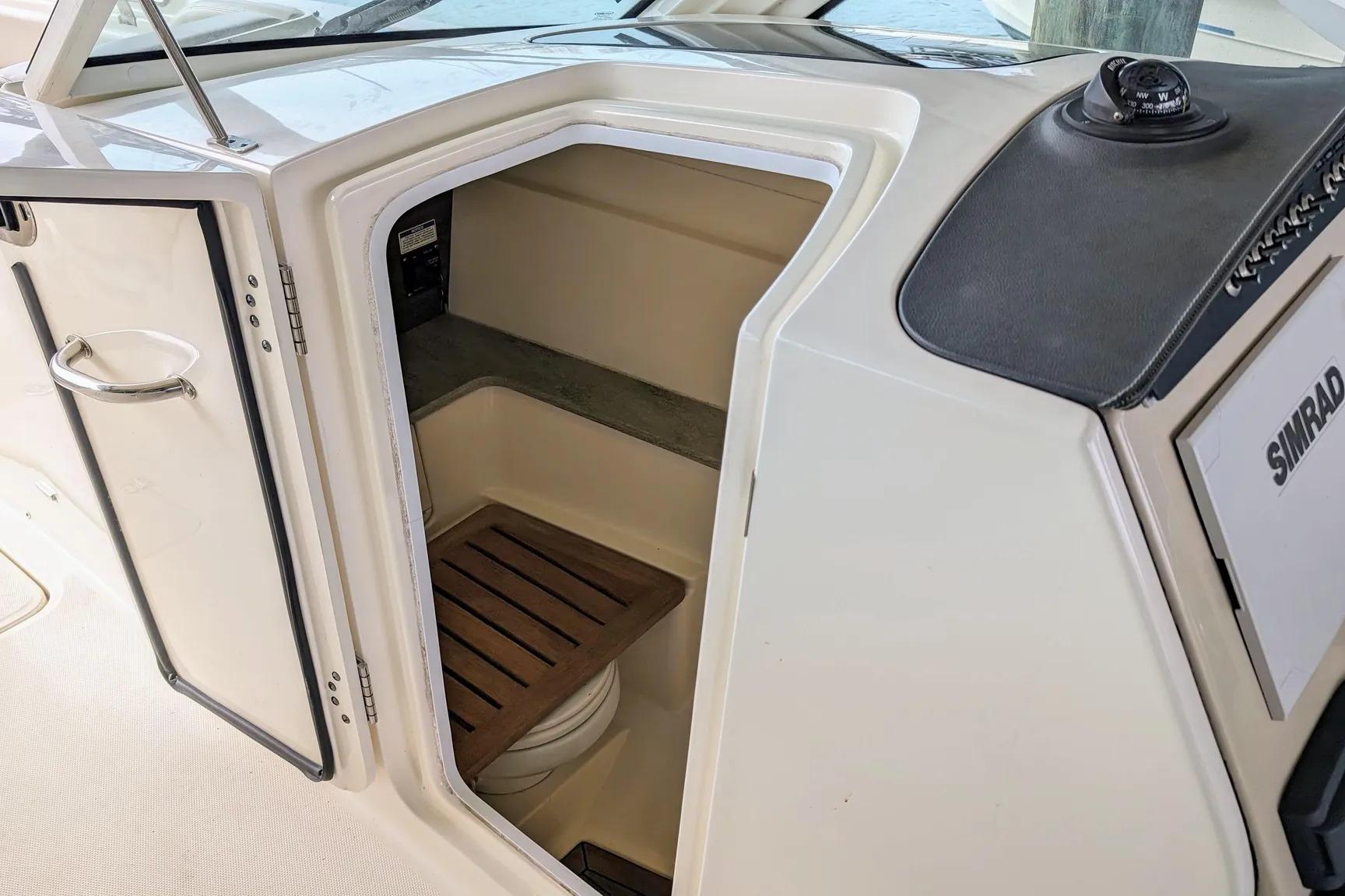 2017 Boston Whaler 320 Vantage cabin interior with open door and wooden flooring.