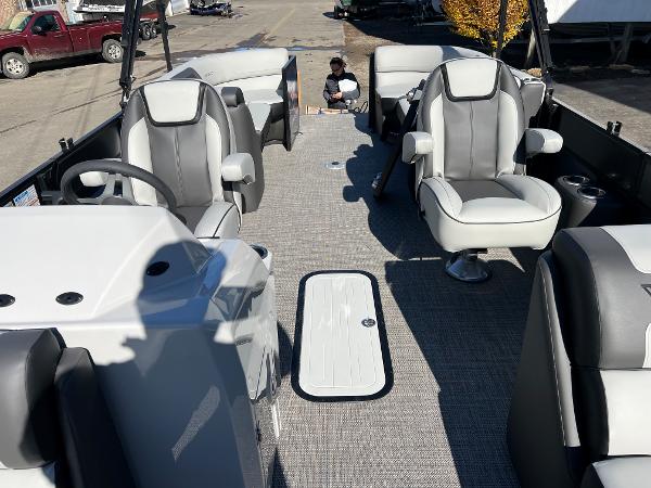 Interior view of a Viaggio Lago 22U Tri Toon boat with gray and white seating.