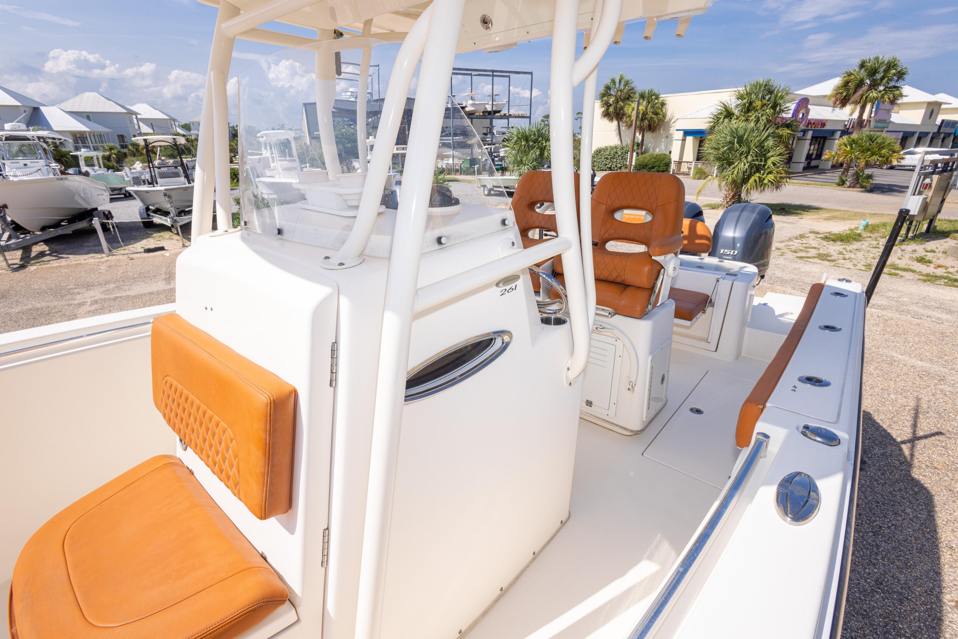 2017 Cobia 261 Center Console boat with tan seating, docked outdoors under clear skies.