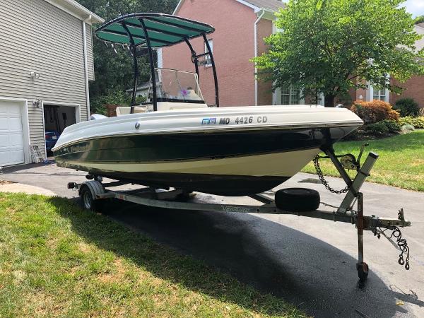2003 Wellcraft 180 Fisherman boat on trailer in residential driveway.
