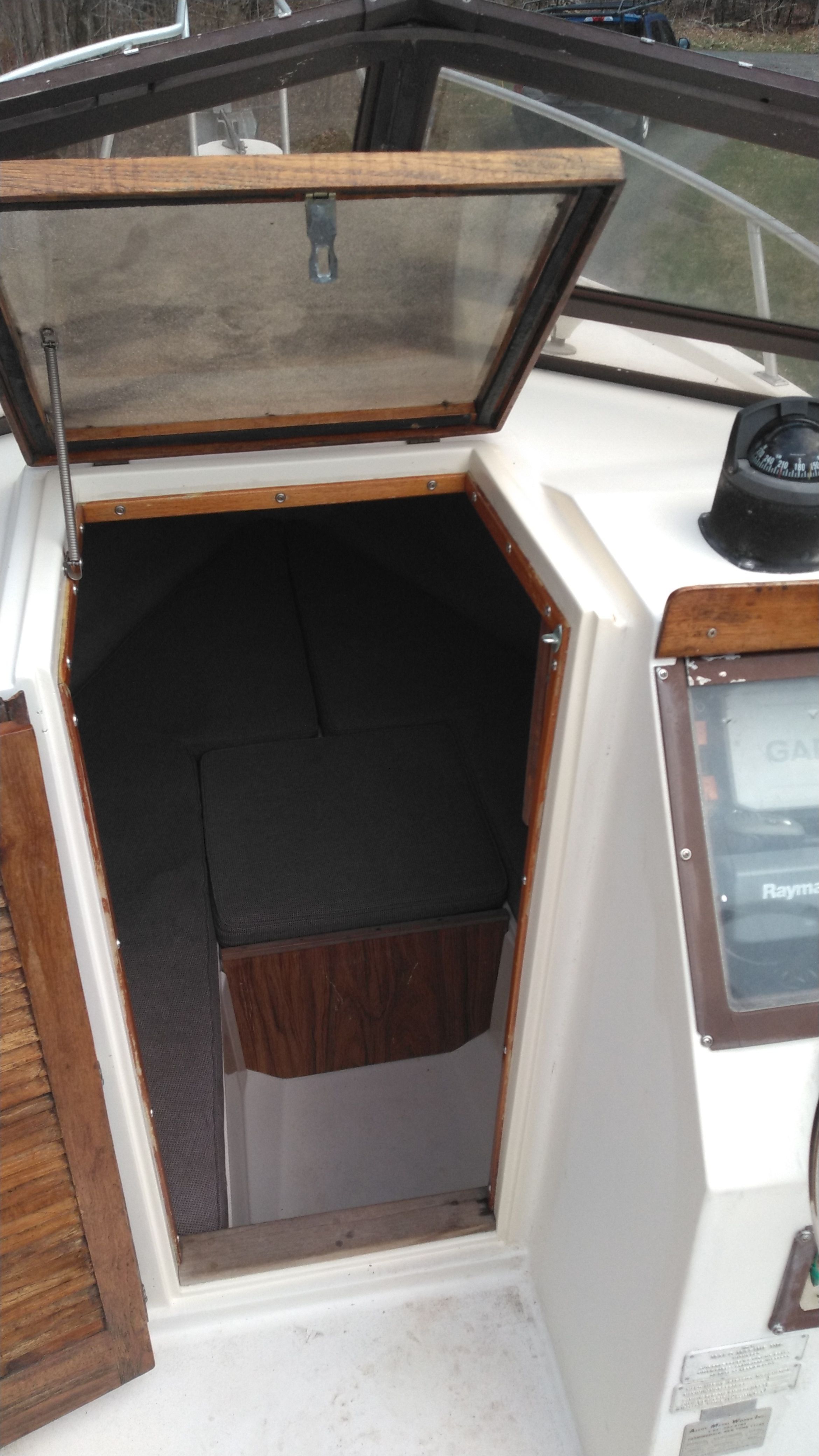A Mako 240 Walk Around boat with cabin entrance and navigation instruments.