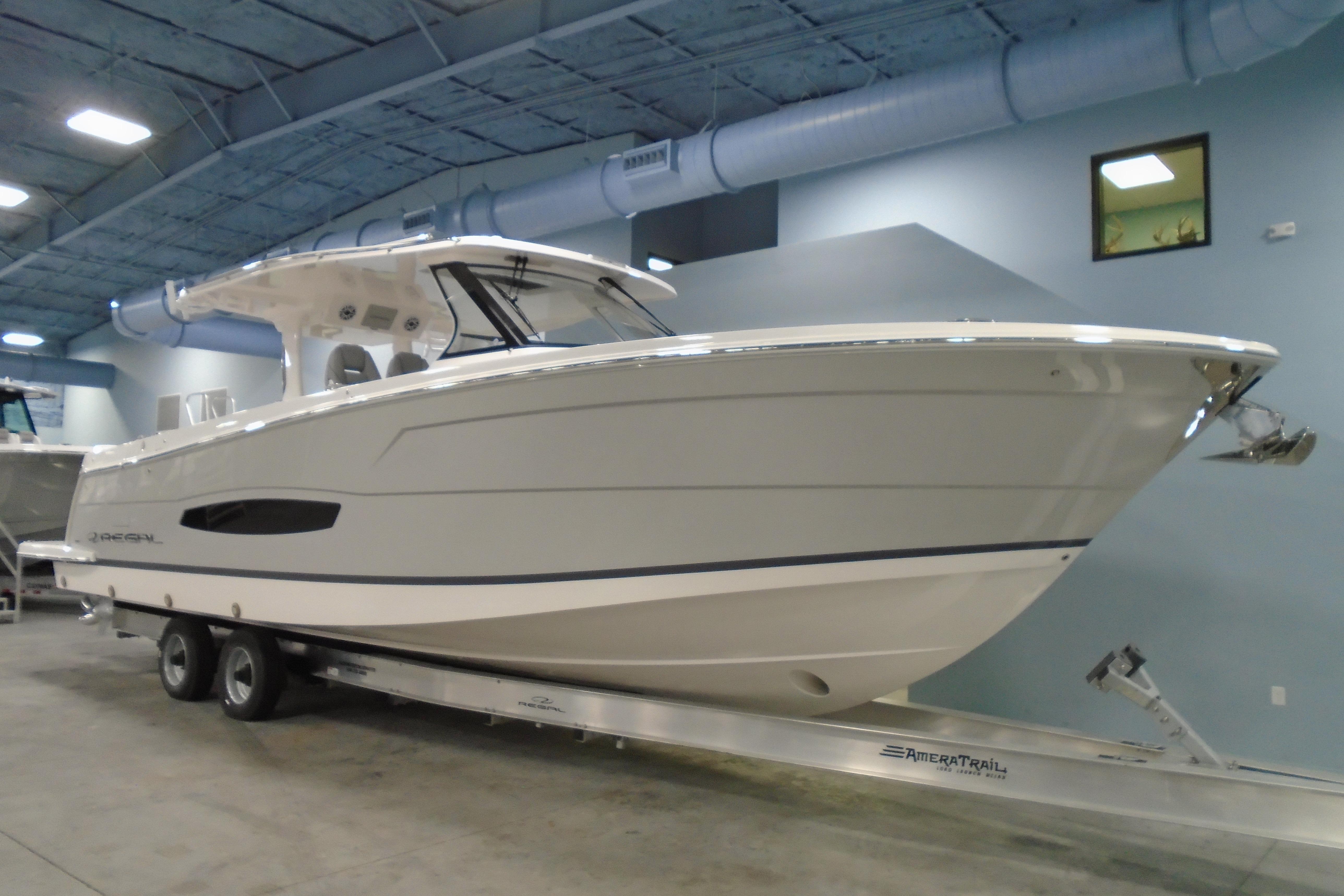 2026 Regal 38 SAV boat on trailer in indoor showroom setting.