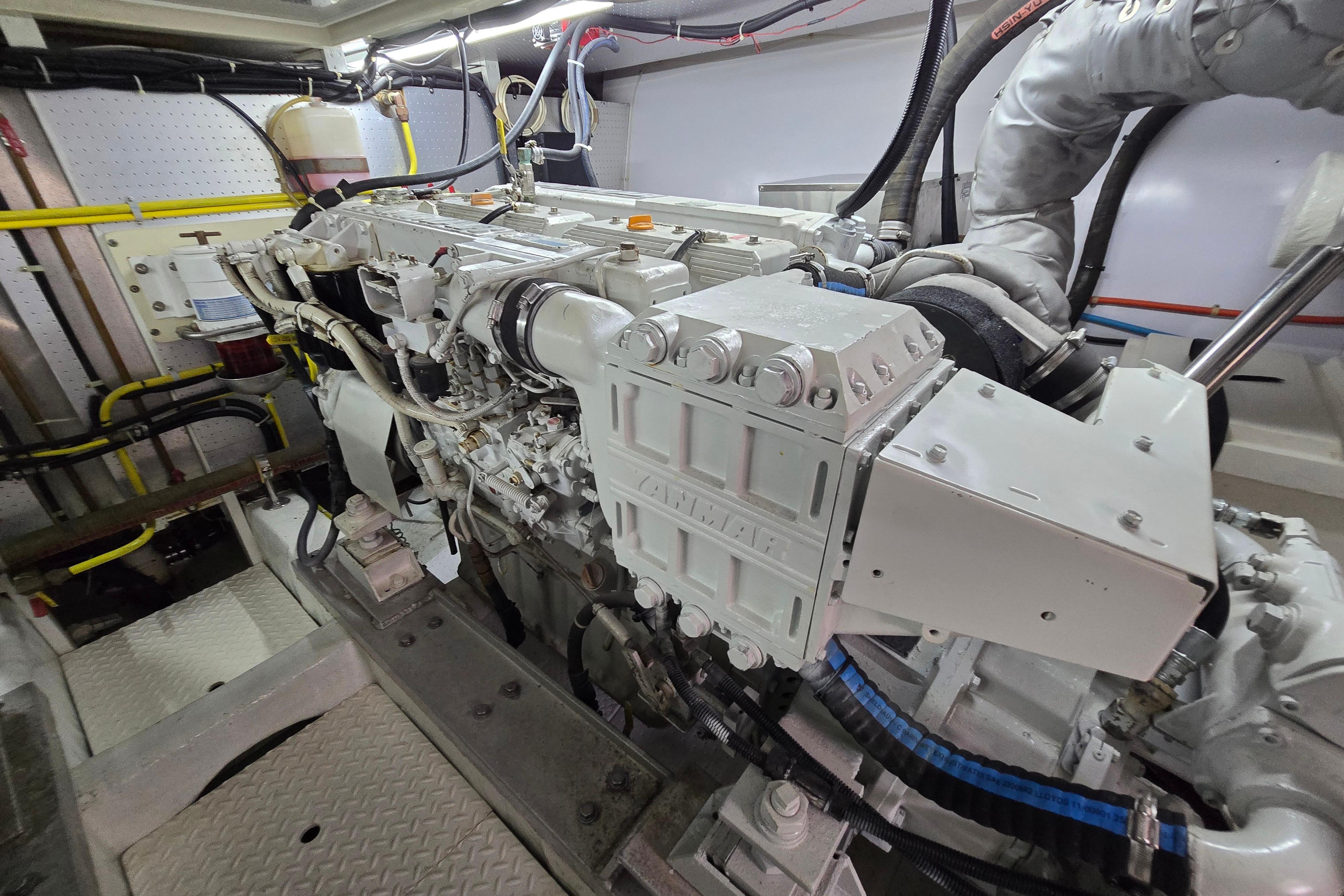 Engine room of a 2004 Grand Harbour 58 yacht, showcasing detailed machinery and components.