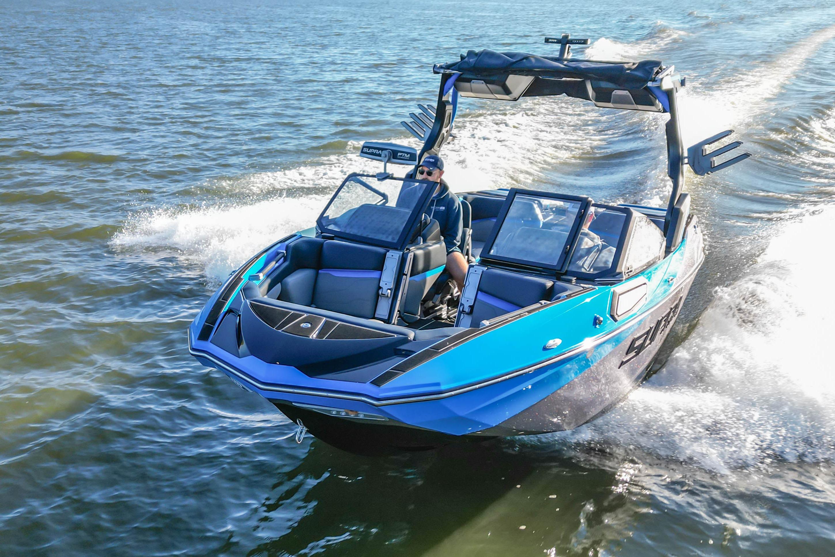 2024 Supra SV 400 boat cruising on water, featuring sleek blue design and modern amenities.