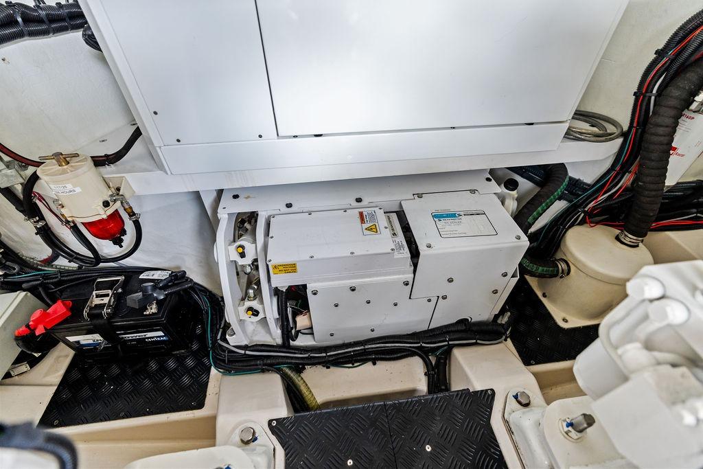 Engine room of 2024 Vanquish Yachts VQ55, showcasing mechanical components and wiring.