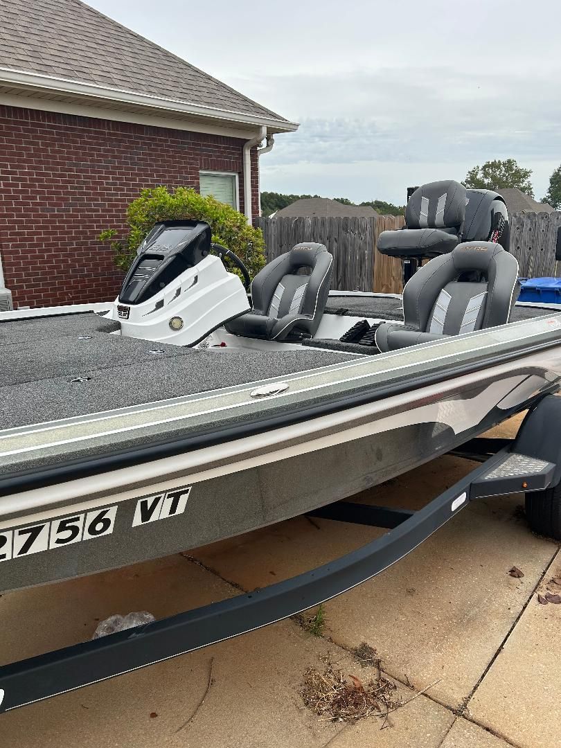 A 2020 Nitro Z18 boat on a trailer in a driveway. It features two gray seats.