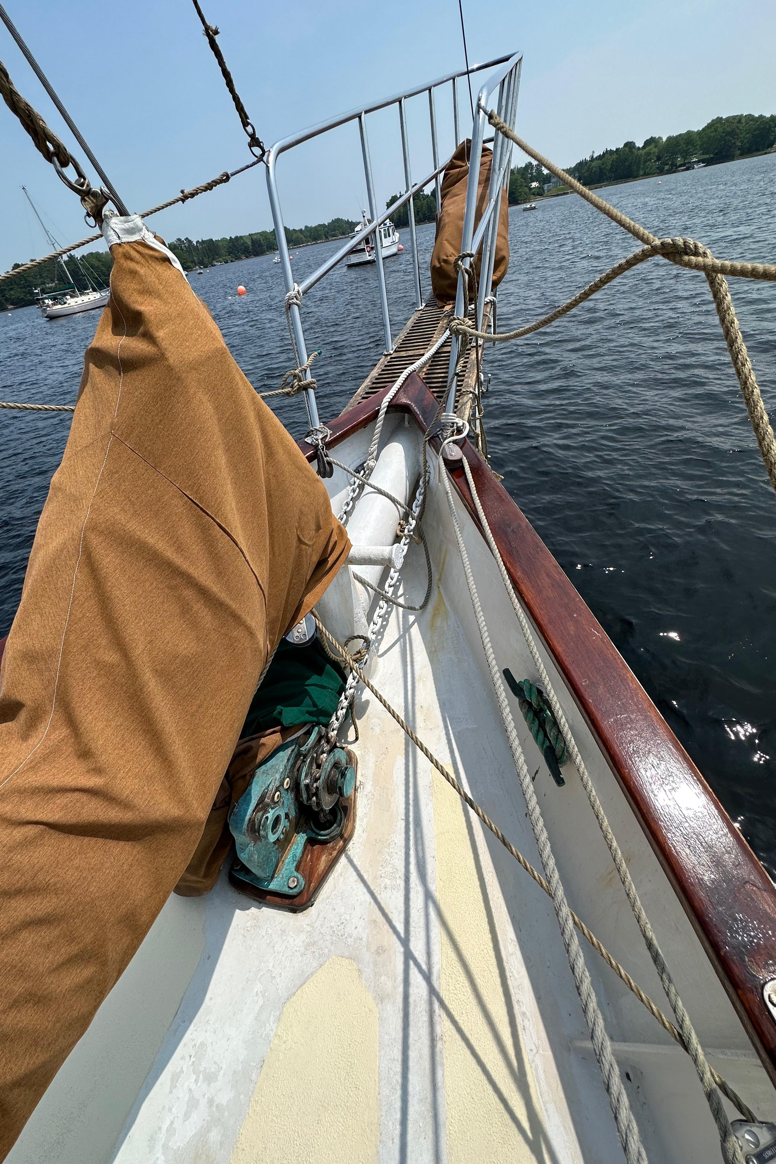 Sailboat deck view, Custom Thomas Colvin "Pipistrelle" 1985, on calm water.