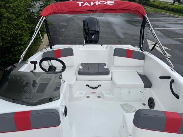 2025 Tahoe T16 boat interior with red and gray seating, steering wheel, and canopy.