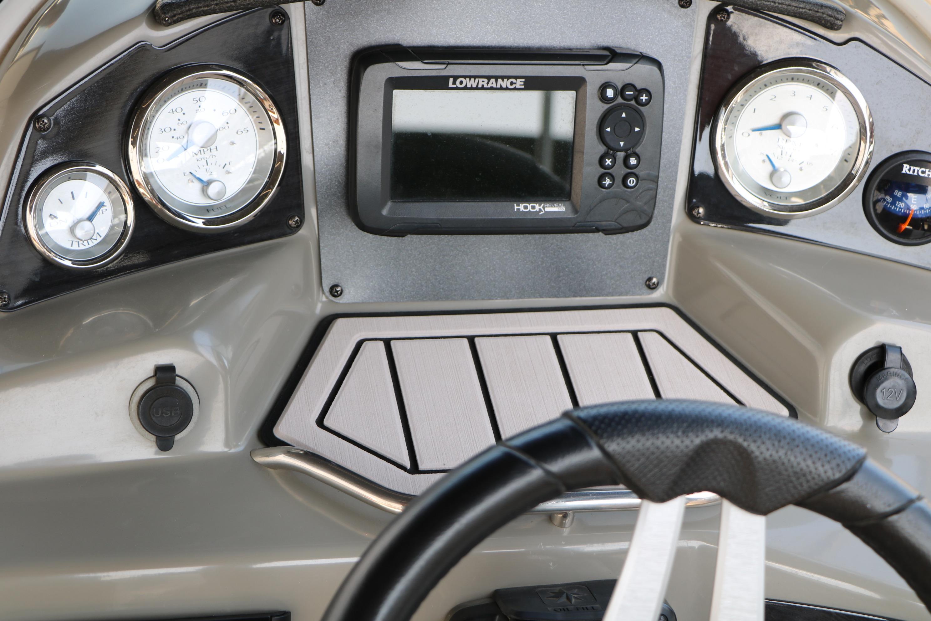 Dashboard of 2022 Stingray 192 SC boat with gauges and navigation system.
