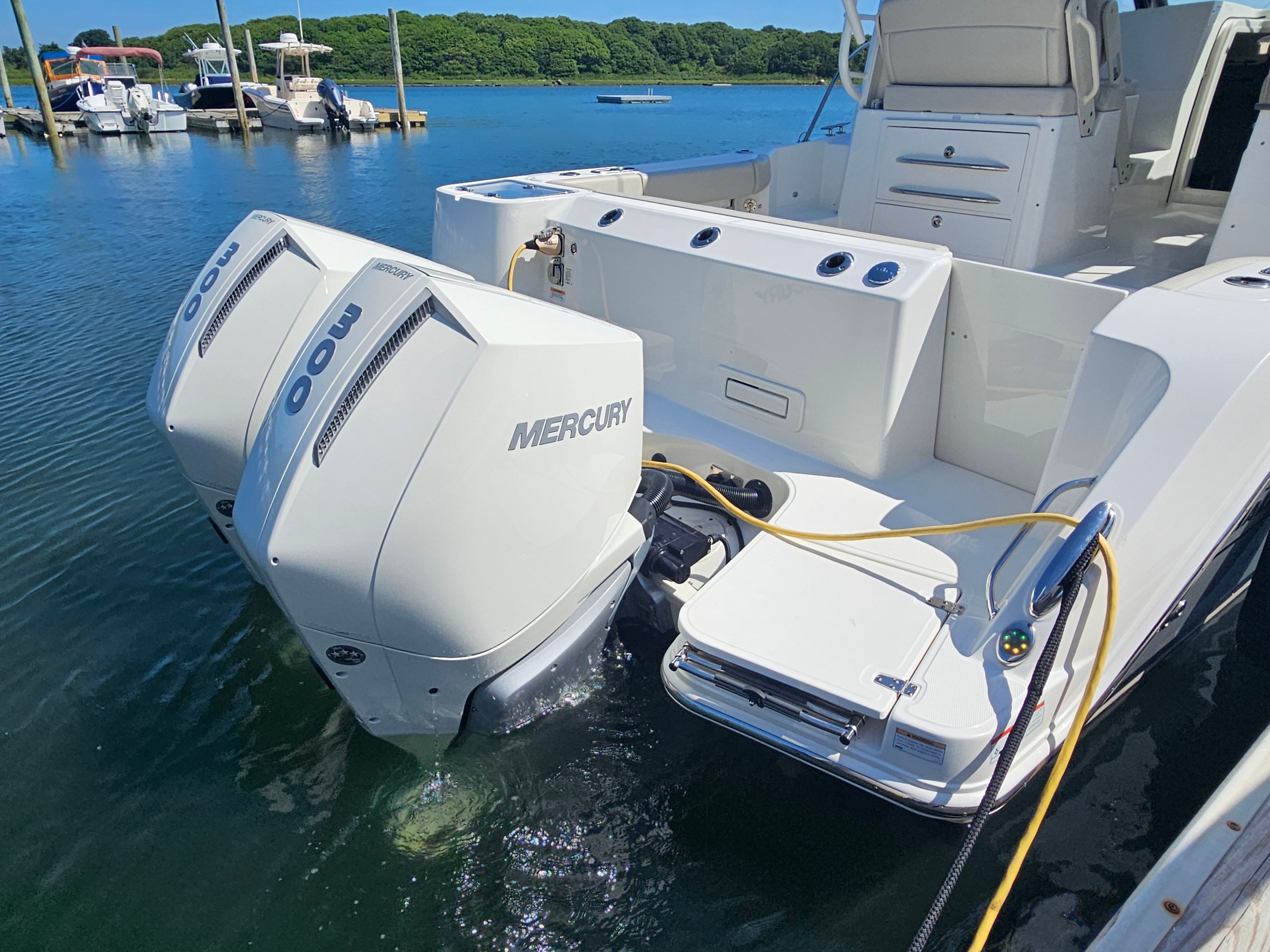 A 2023 Boston Whaler 325 Conquest is on the water. Two Mercury engines are visible.