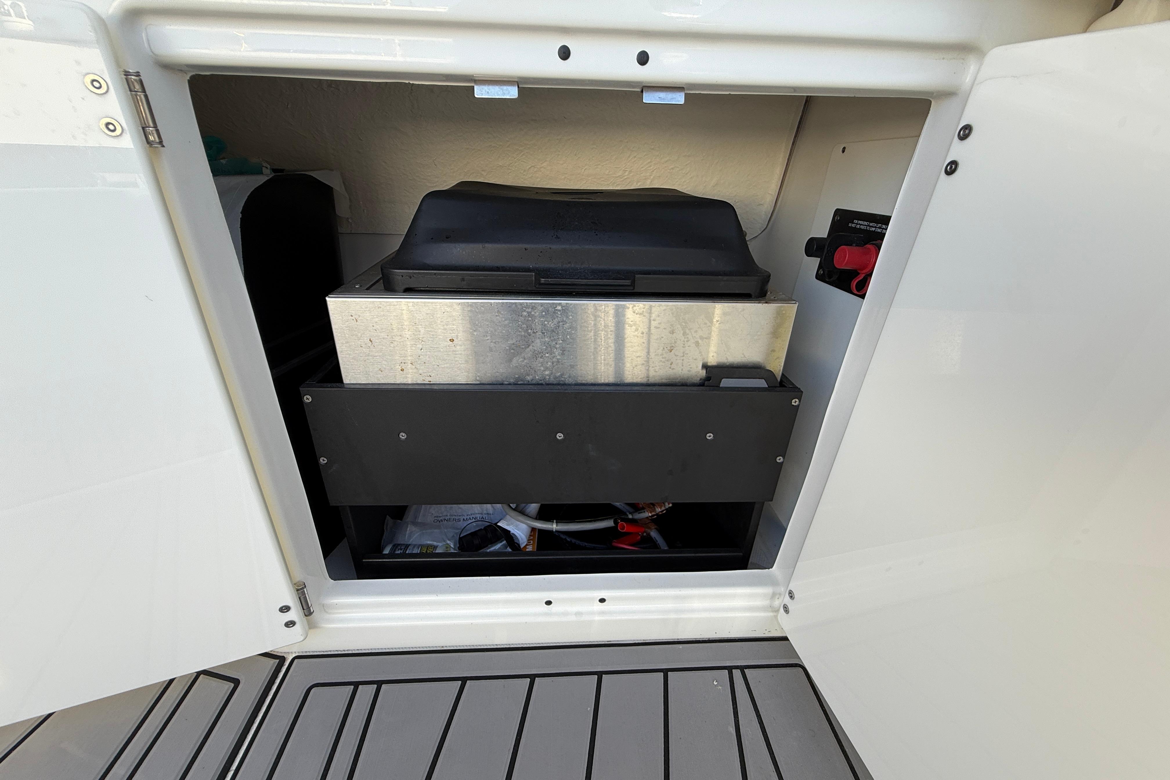 2022 Monterey 385SS Super Sport storage compartment with equipment inside.