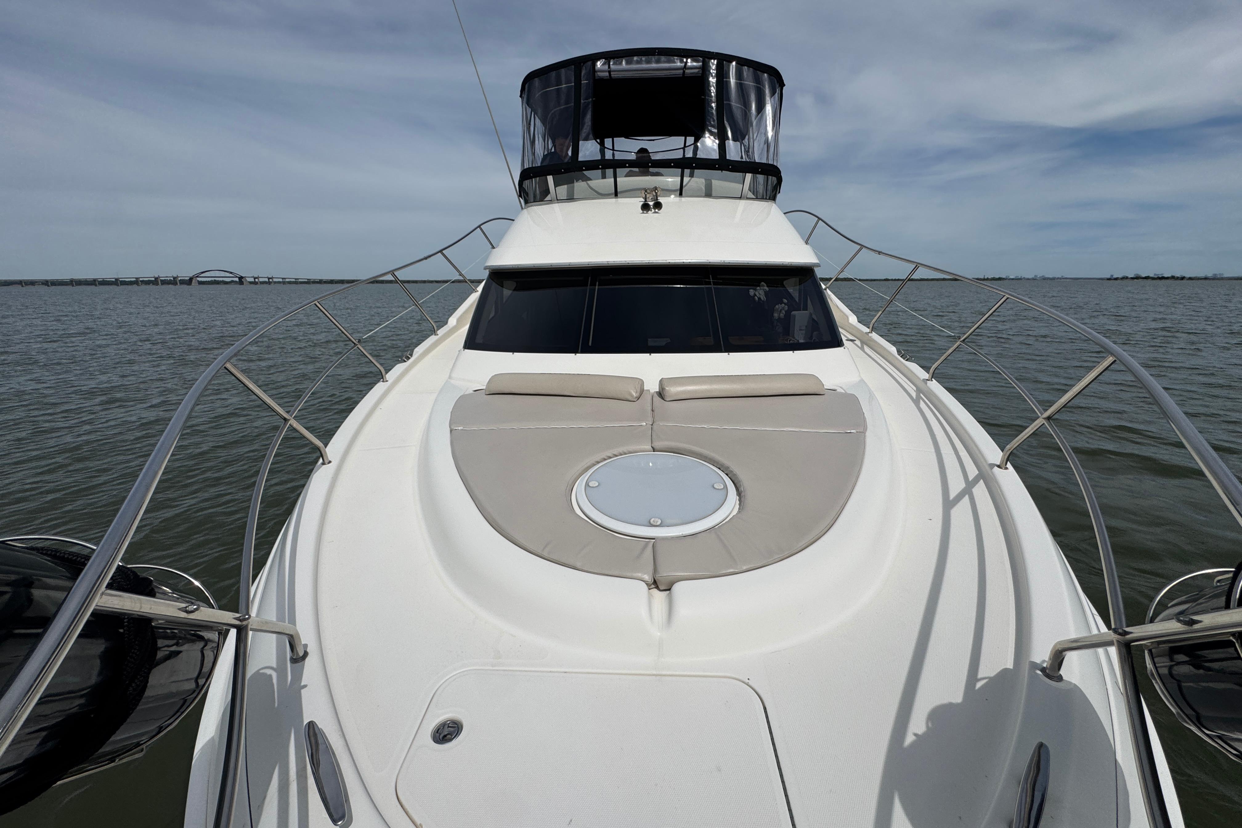 2003 Silverton 39 Motor Yacht on calm water, showcasing sleek design and spacious deck.