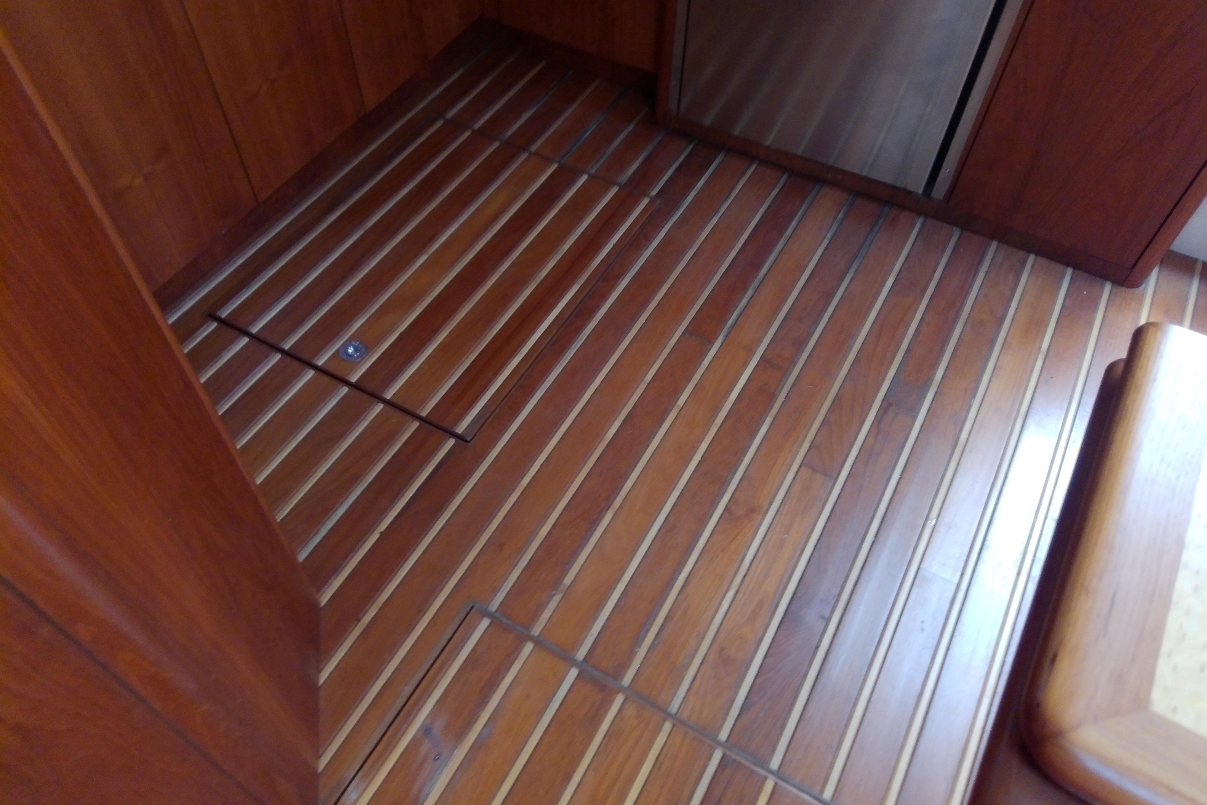 Teak flooring inside a 2000 Tiara Yachts 4100 Open, showcasing elegant wood finish.