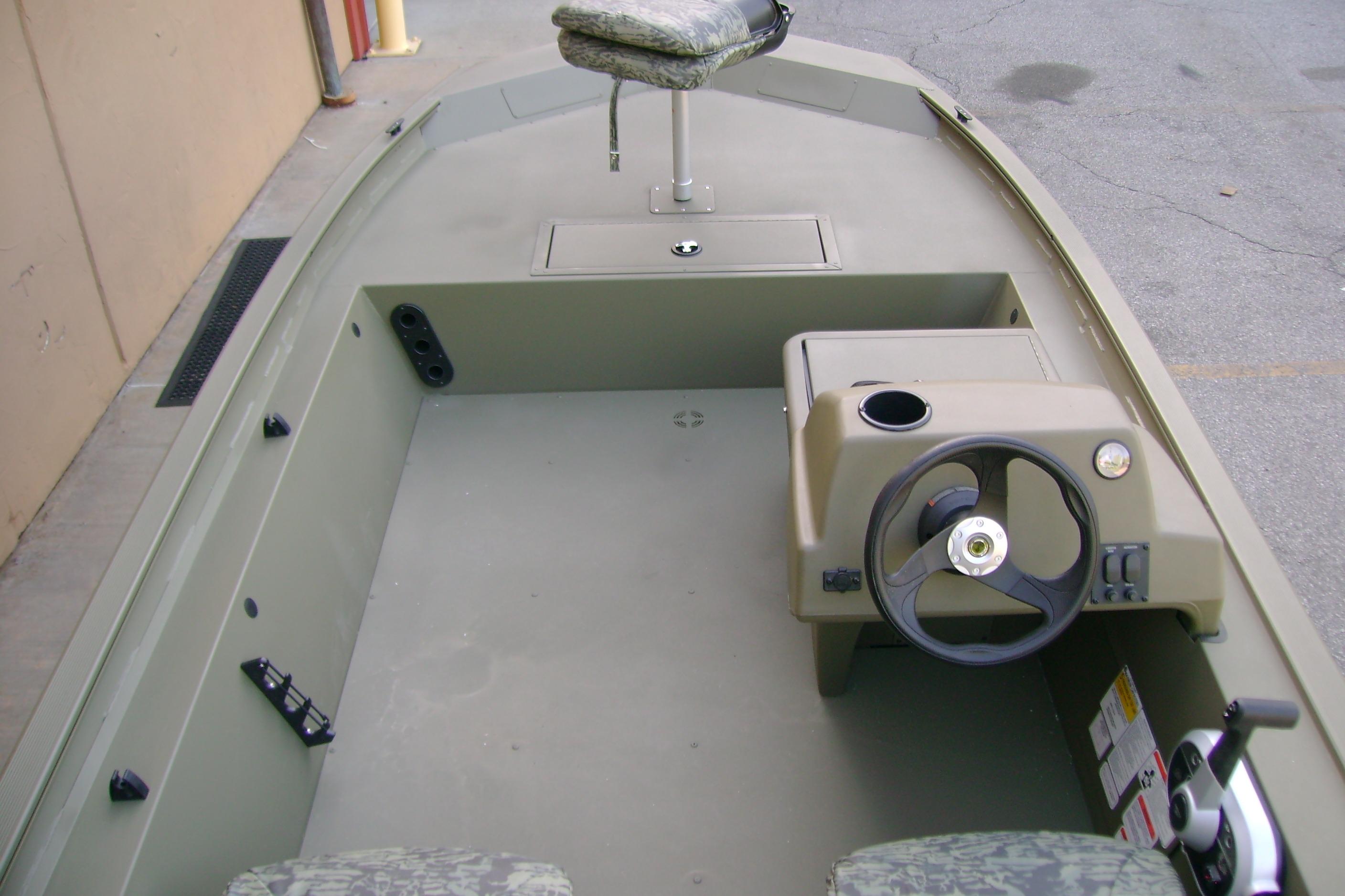 2026 Tracker Grizzly 1754 SC boat interior with steering console and seating.