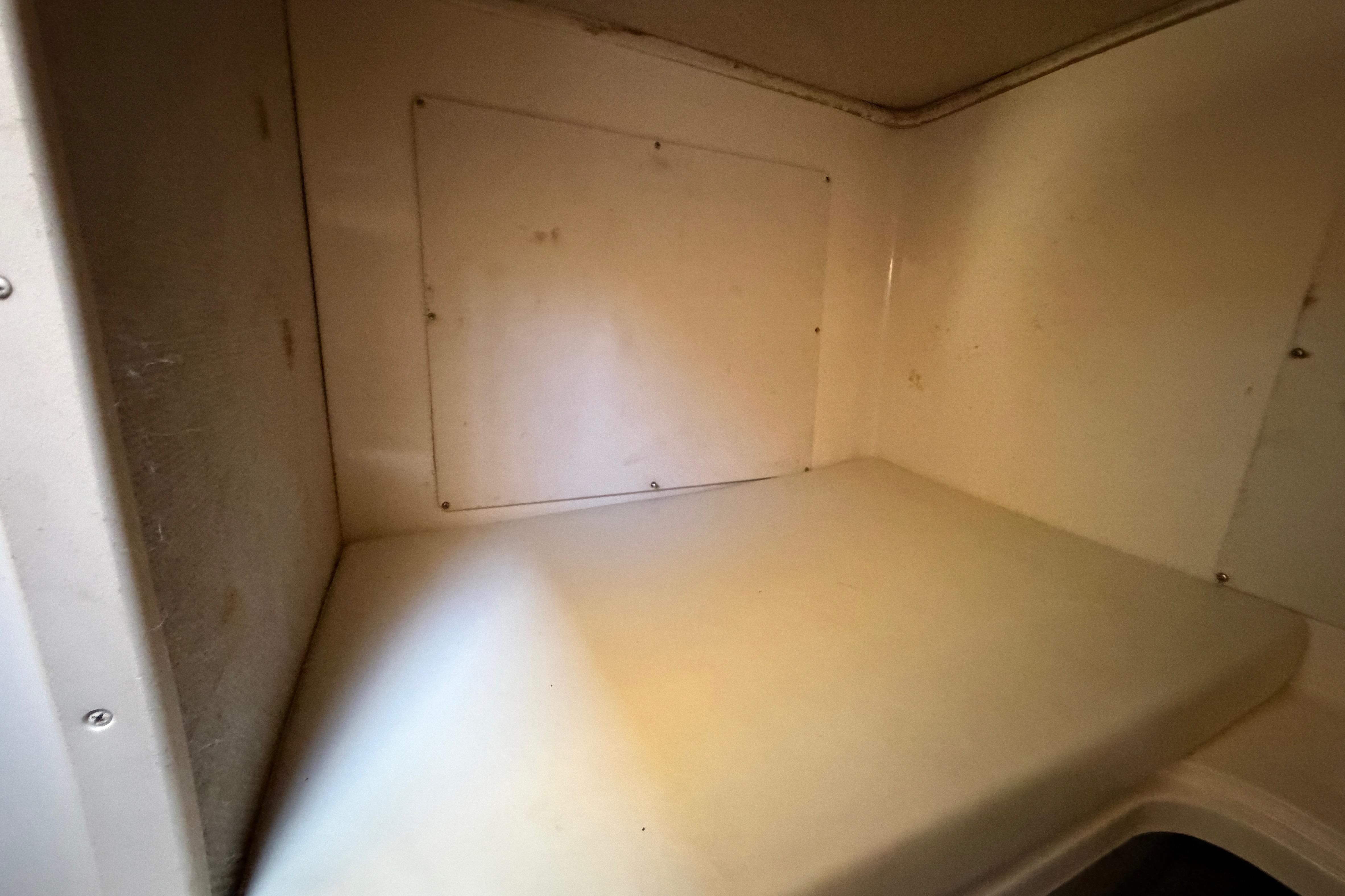 Interior cabin of 2006 Grady-White Sailfish 282 boat, featuring a compact sleeping area.