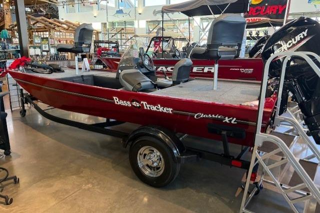 2025 Tracker Bass Tracker Classic XL boat displayed in showroom with Mercury engine.