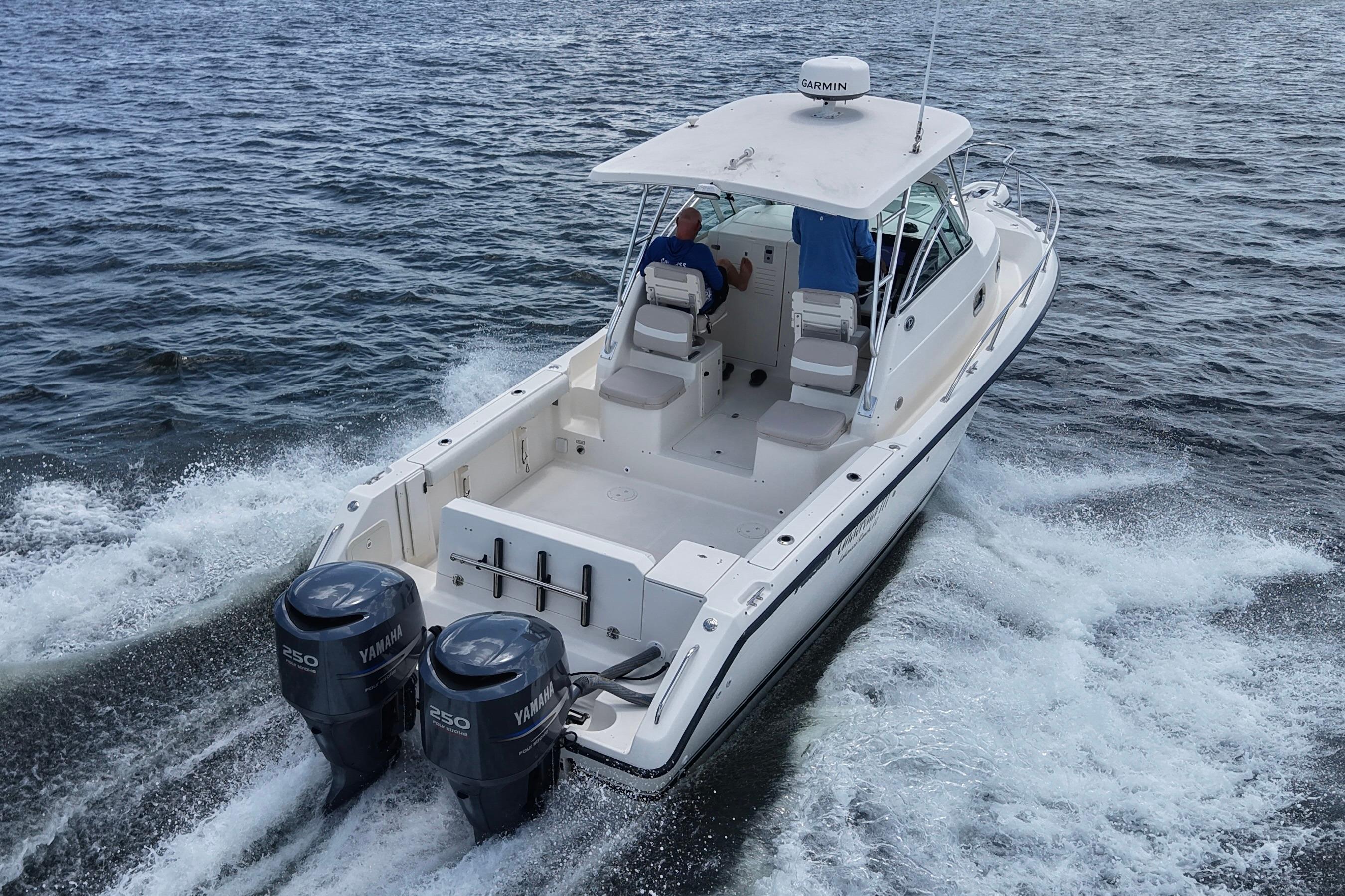 2004 Pursuit 2870 Walkaround boat cruising on open water with twin Yamaha engines.