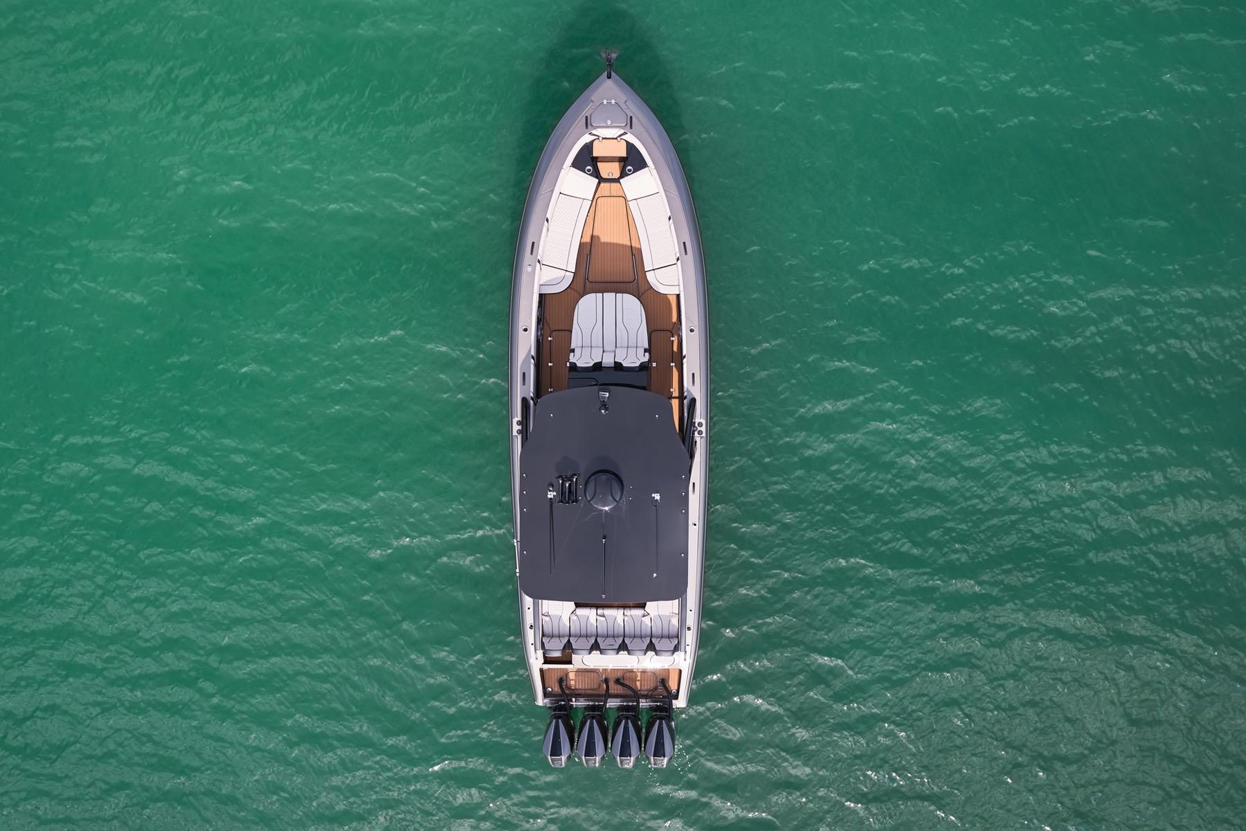 Aerial view of 2025 Midnight Express 37 Open boat on turquoise water.