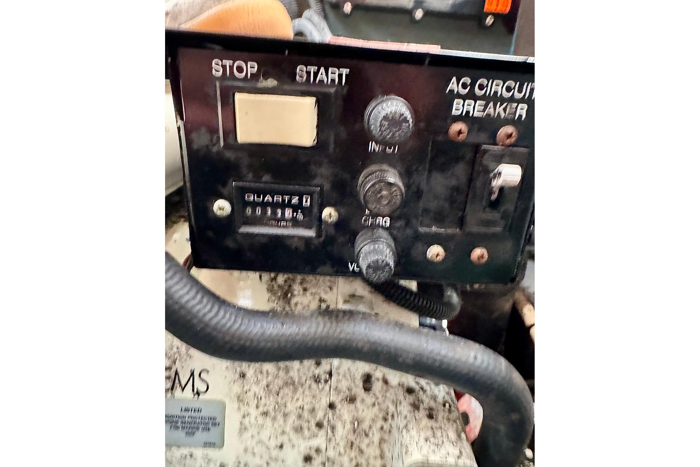 Control panel of a 2003 Sea Ray 300 Sundancer boat with AC circuit breaker.
