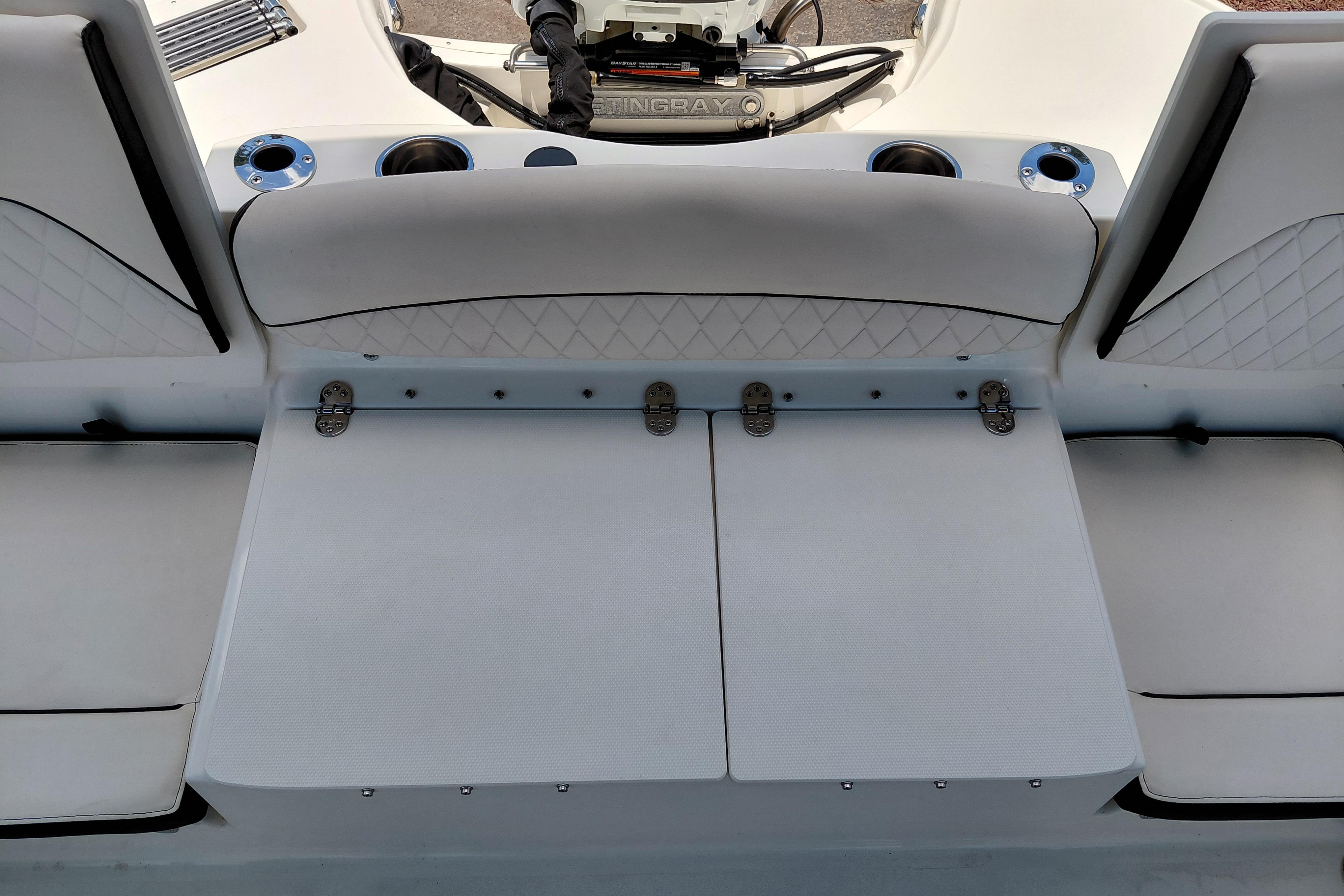 2023 Stingray 206 CC boat interior with cushioned seating and cup holders.
