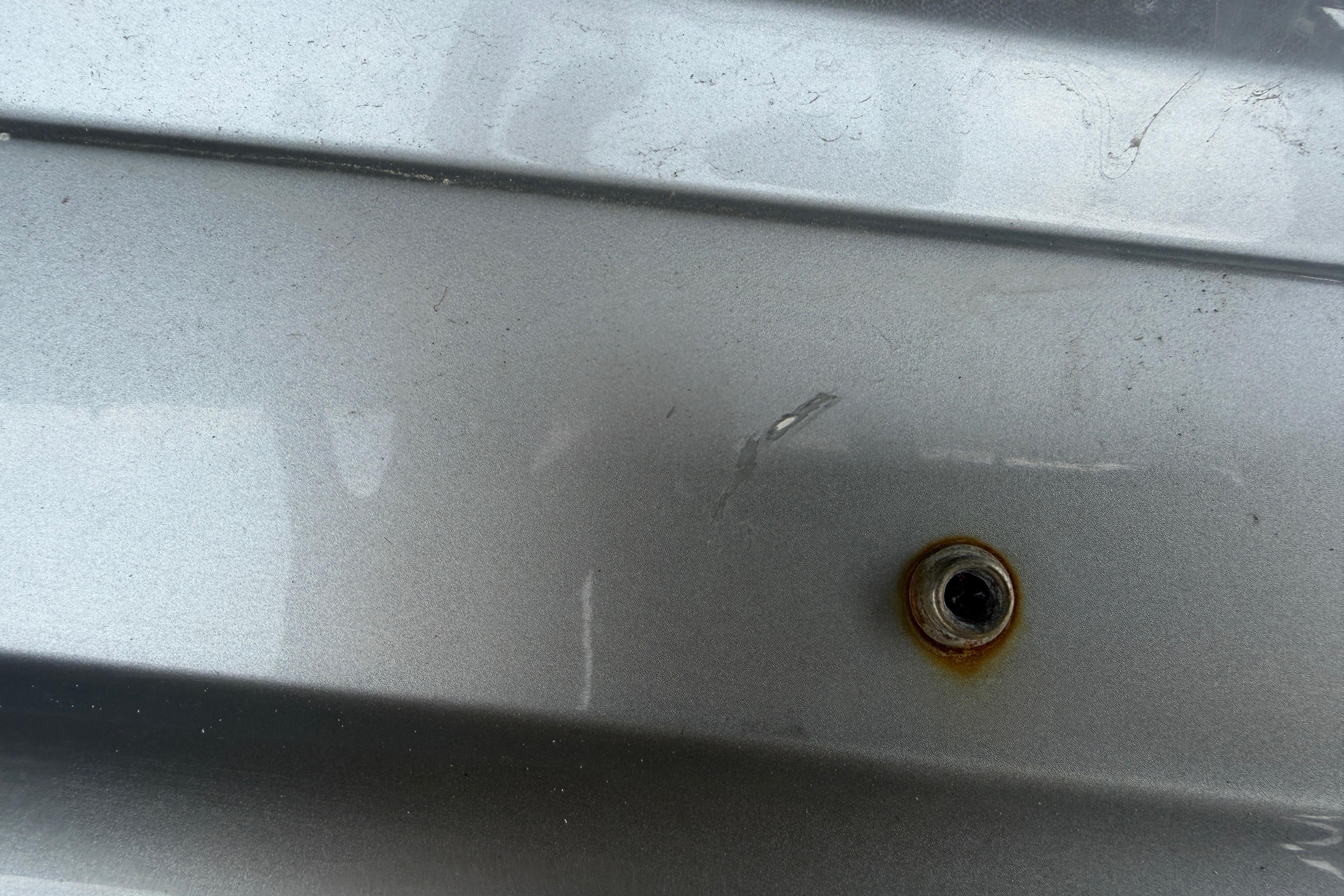 Close-up of a 2013 Nor-Tech 477 SPX Vee Bottom boat hull with a visible bolt.