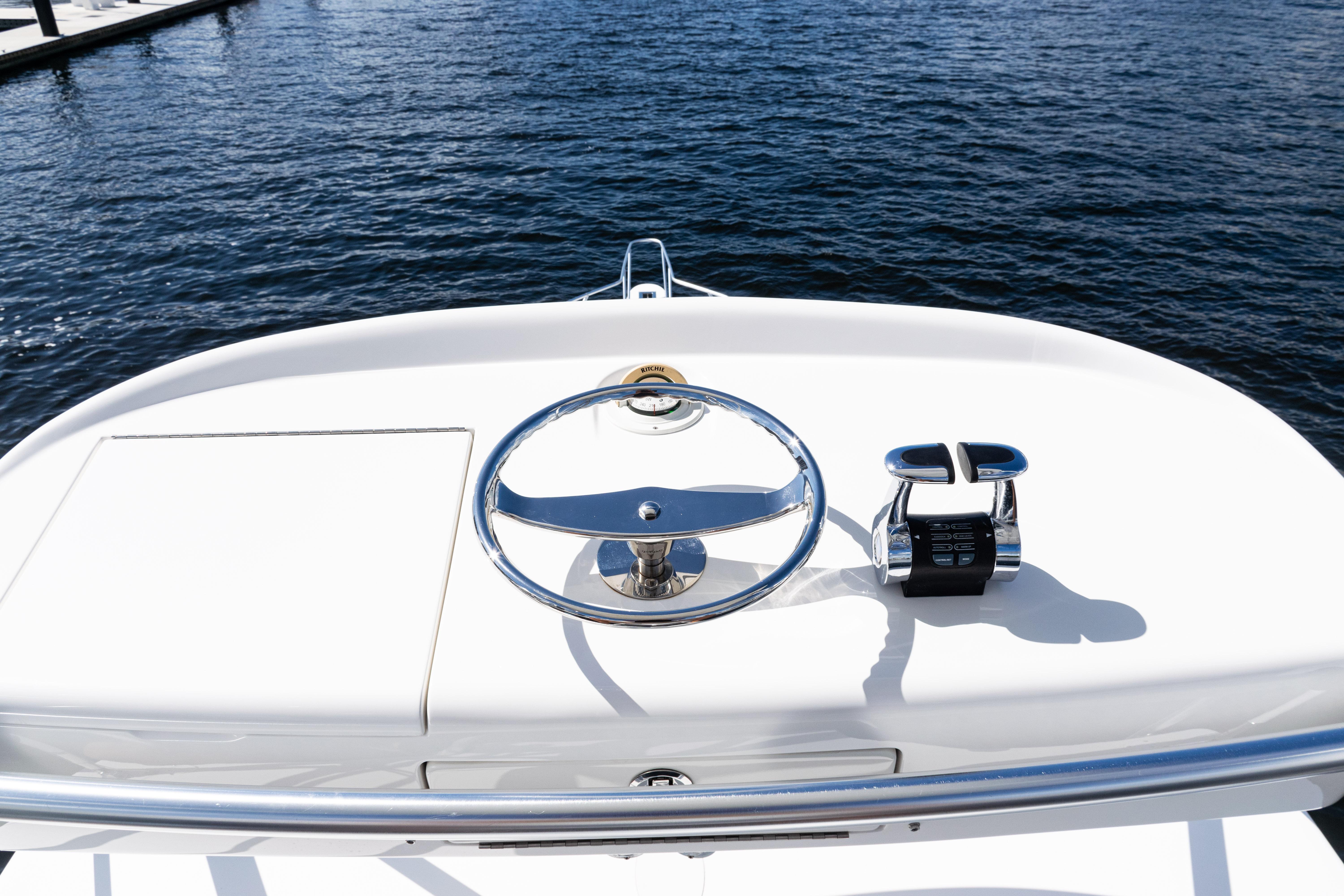 Steering wheel and controls of 2021 Viking 44 Open yacht on water.