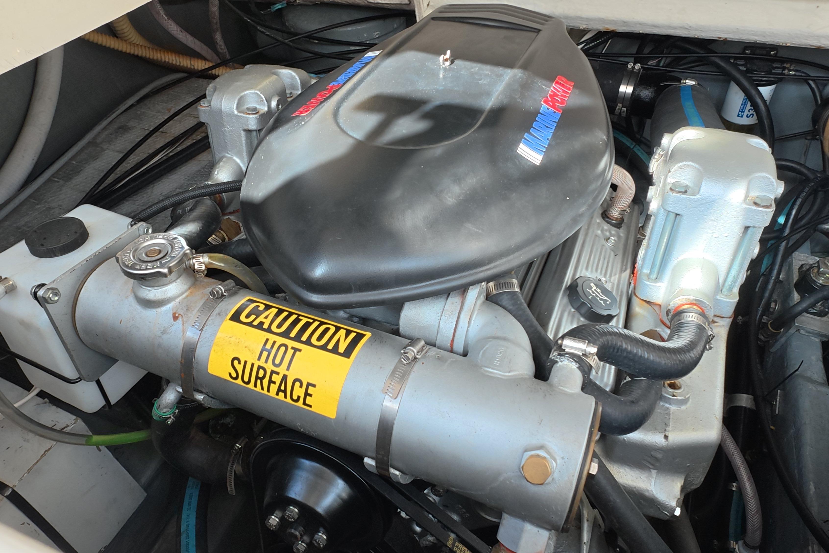 Engine compartment of a 1992 Luhrs 300 Tournament boat with caution label.