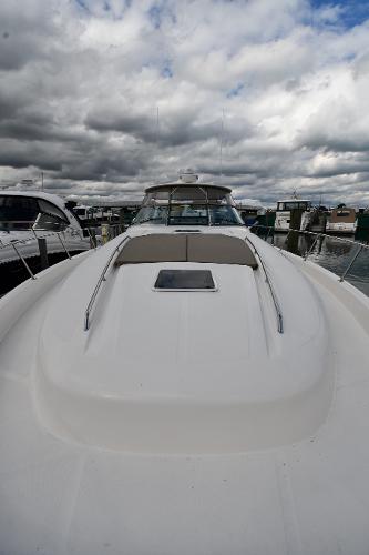 2003 Sea Ray 460 Sundancer yacht docked under cloudy skies.