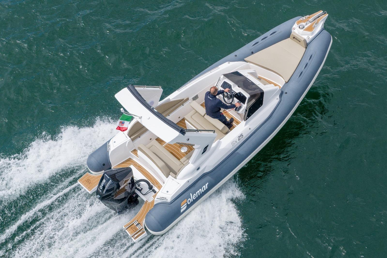 2026 Solemar SX25 boat cruising on open water, featuring sleek design and powerful engine.