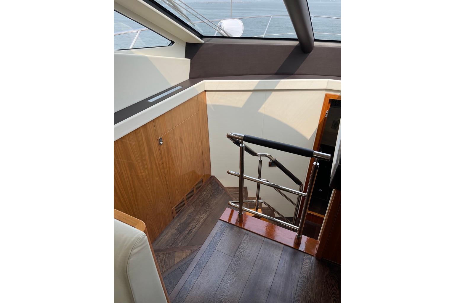 Interior staircase of 2016 Sunseeker Manhattan 65 yacht with wooden and metal finishes.