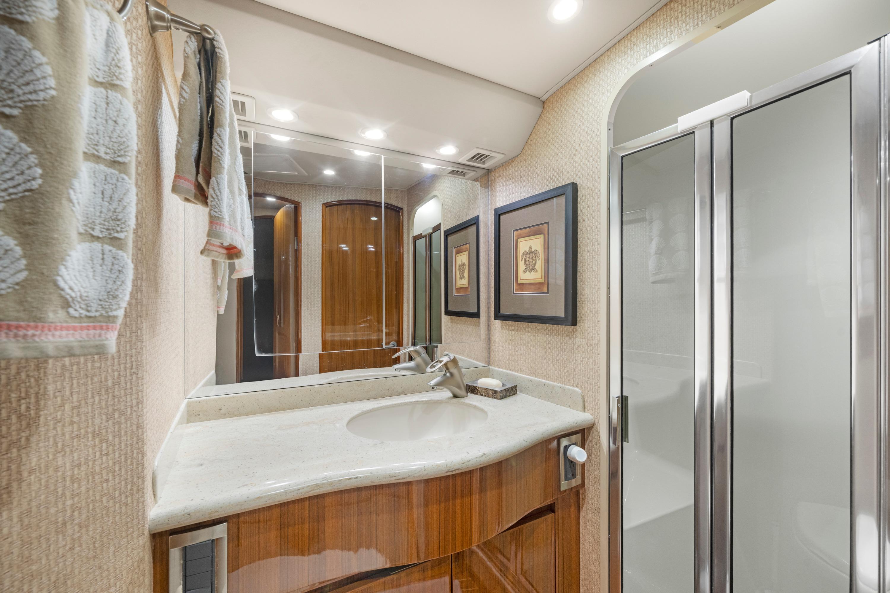 Luxurious bathroom interior of 2009 Viking 50 Convertible yacht with modern fixtures.