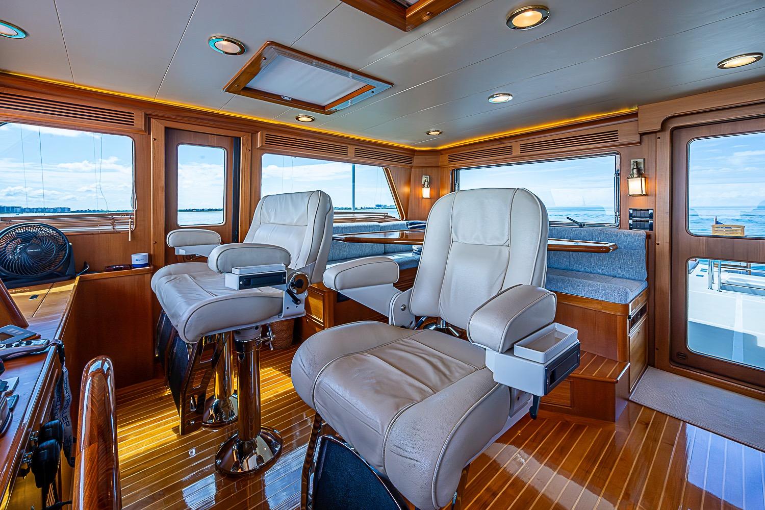 Luxurious interior of 2014 Marlow 80 Explorer yacht with plush seating and panoramic windows.