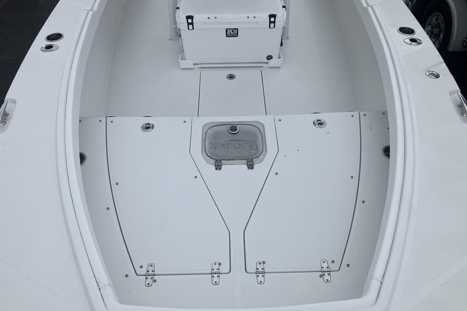 2026 BlackJack 256 Coastal boat deck with storage compartments and seating area.