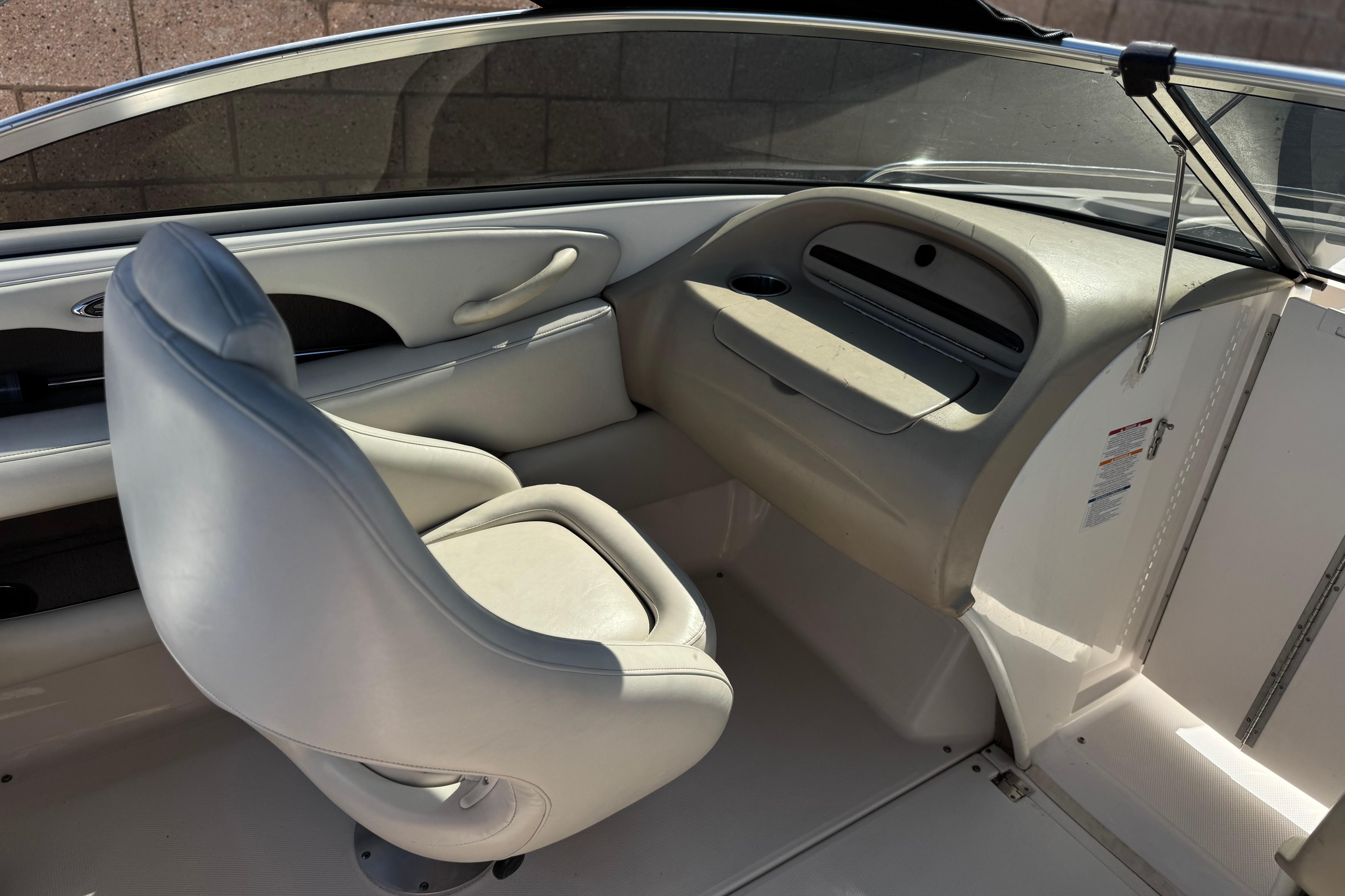 Interior of a 2002 Chaparral 186 SSi boat featuring a sleek white captain's chair.