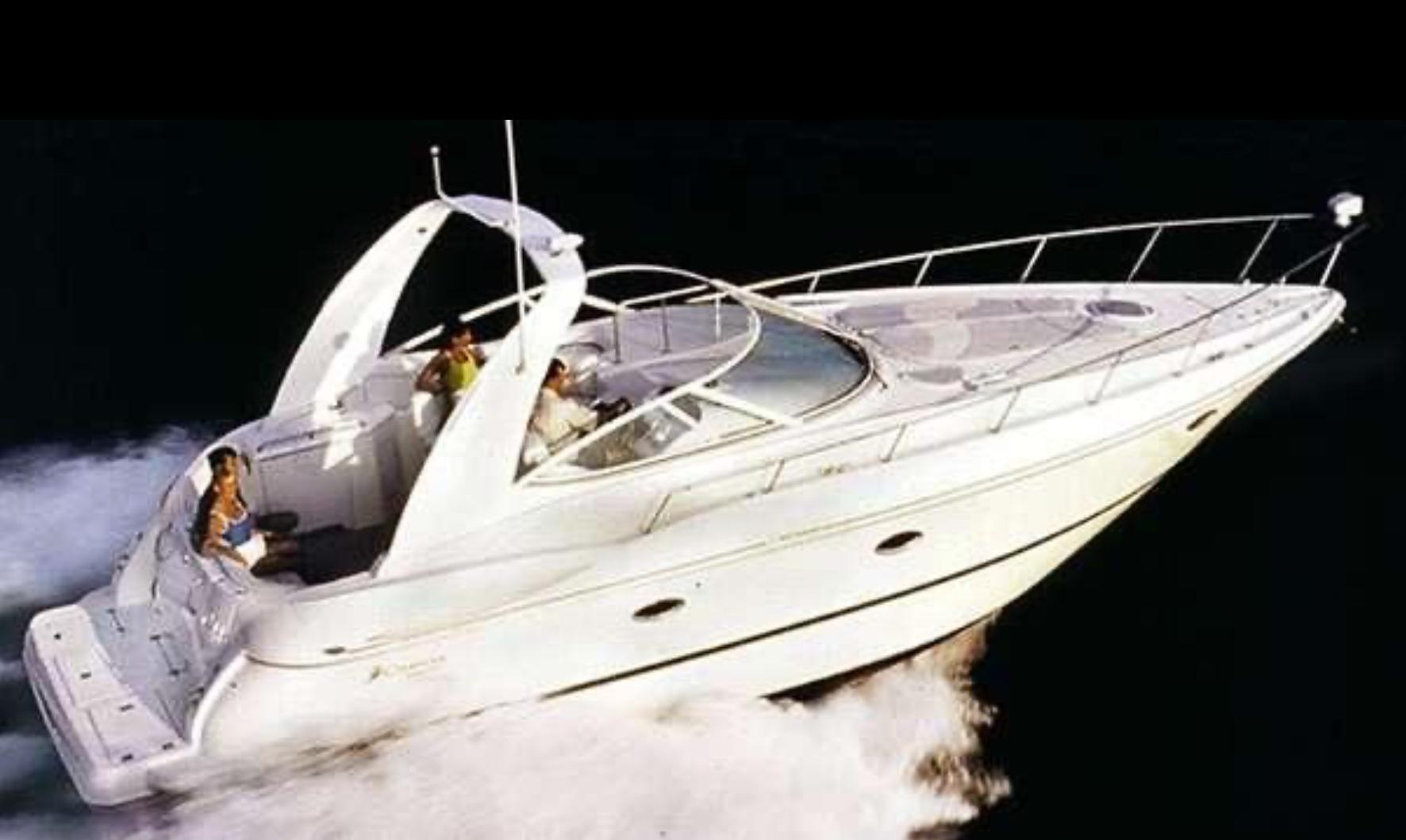 2000 Cruisers 3672 yacht speeding on water, sleek design, white exterior.